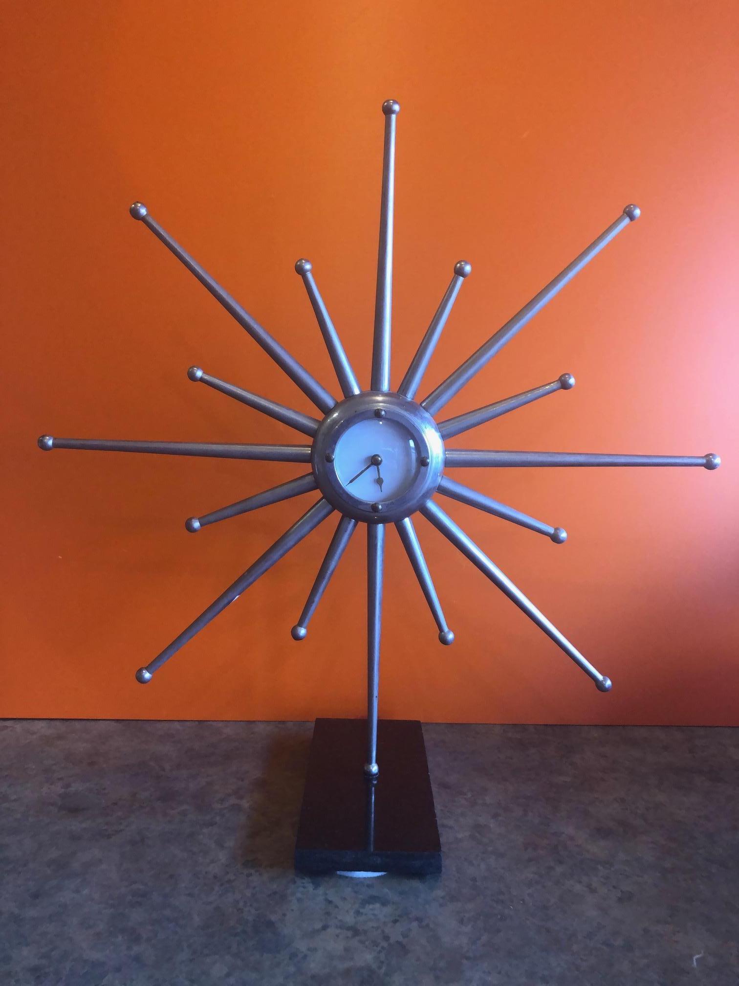 Striking midcentury silver plated sunburst mantel (fireplace) clock on a black marble base (4