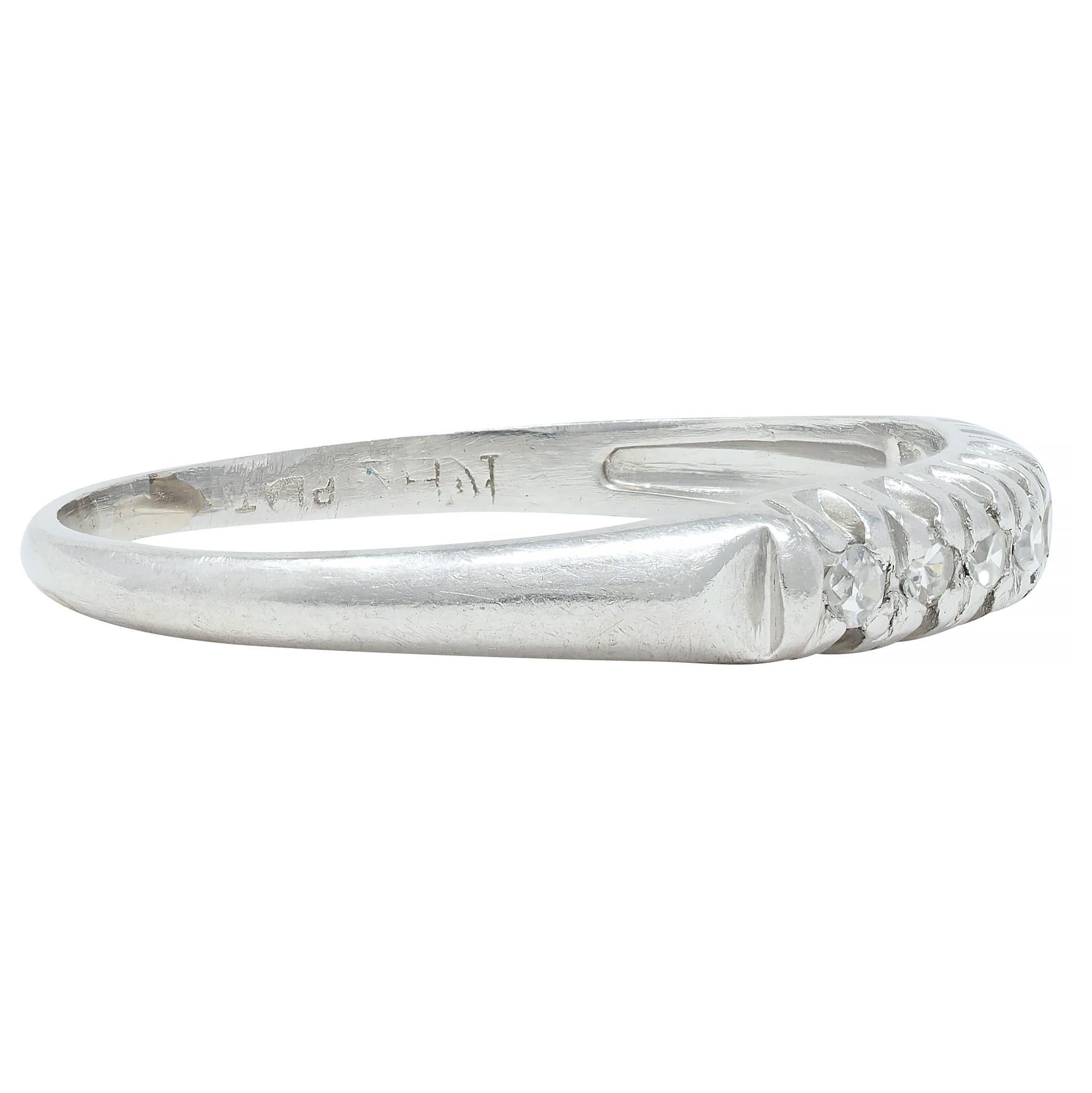 Featuring seven single cut diamonds weighing approximately 0.14 carat total 
G color with VS2 clarity - prong set east to west with grooved profile
Accented by arrow motif shoulders and knife edge shank
Stamped for platinum
With partial maker's