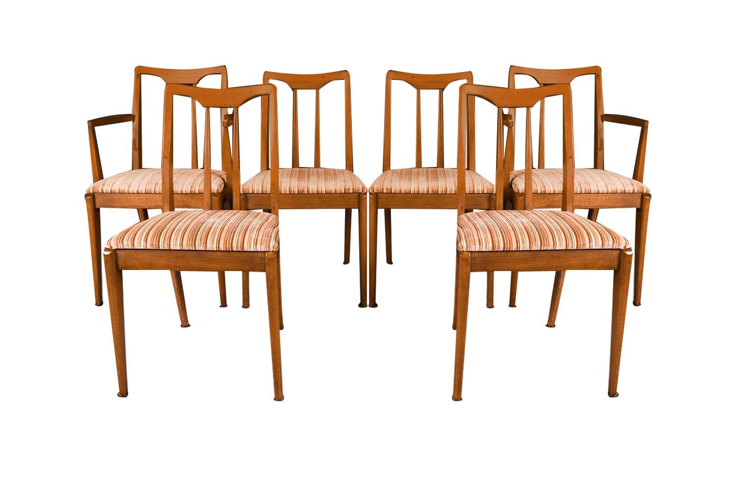 A set of six extremely sought after, gorgeous 1960s, modern walnut side/dining chairs designed by John Van Koert for the Drexel Projection line. Featuring a full matching set of six, two which are arm chairs, each remains in original condition