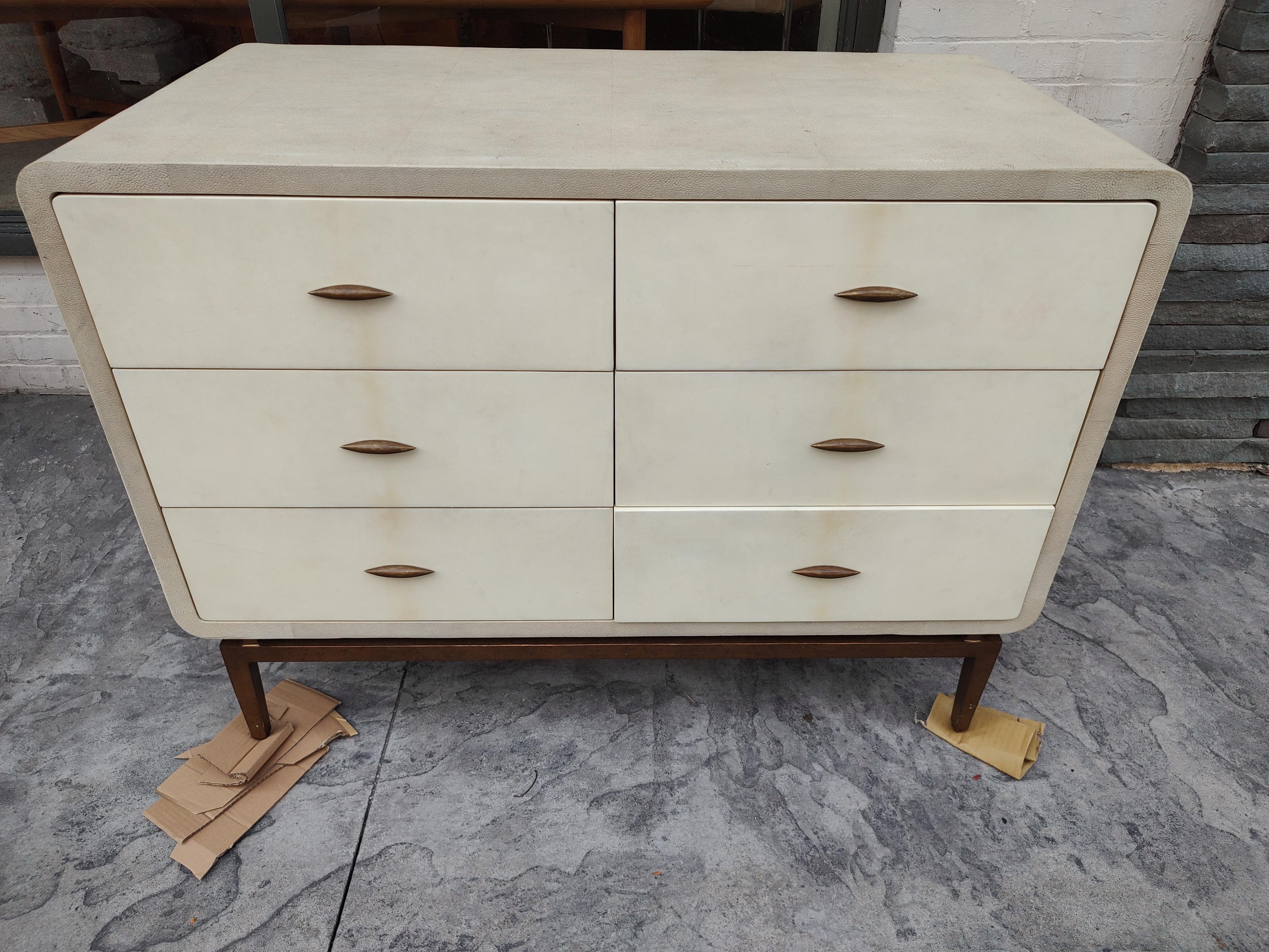 Fabulous chest of drawers which the case piece is covered in Shagreen. Drawers are enameled with a Gilt bronze pulls and base. A true quality piece. In excellent vintage condition with minimal wear. Drawers all glide nice and smooth. Heavy solid