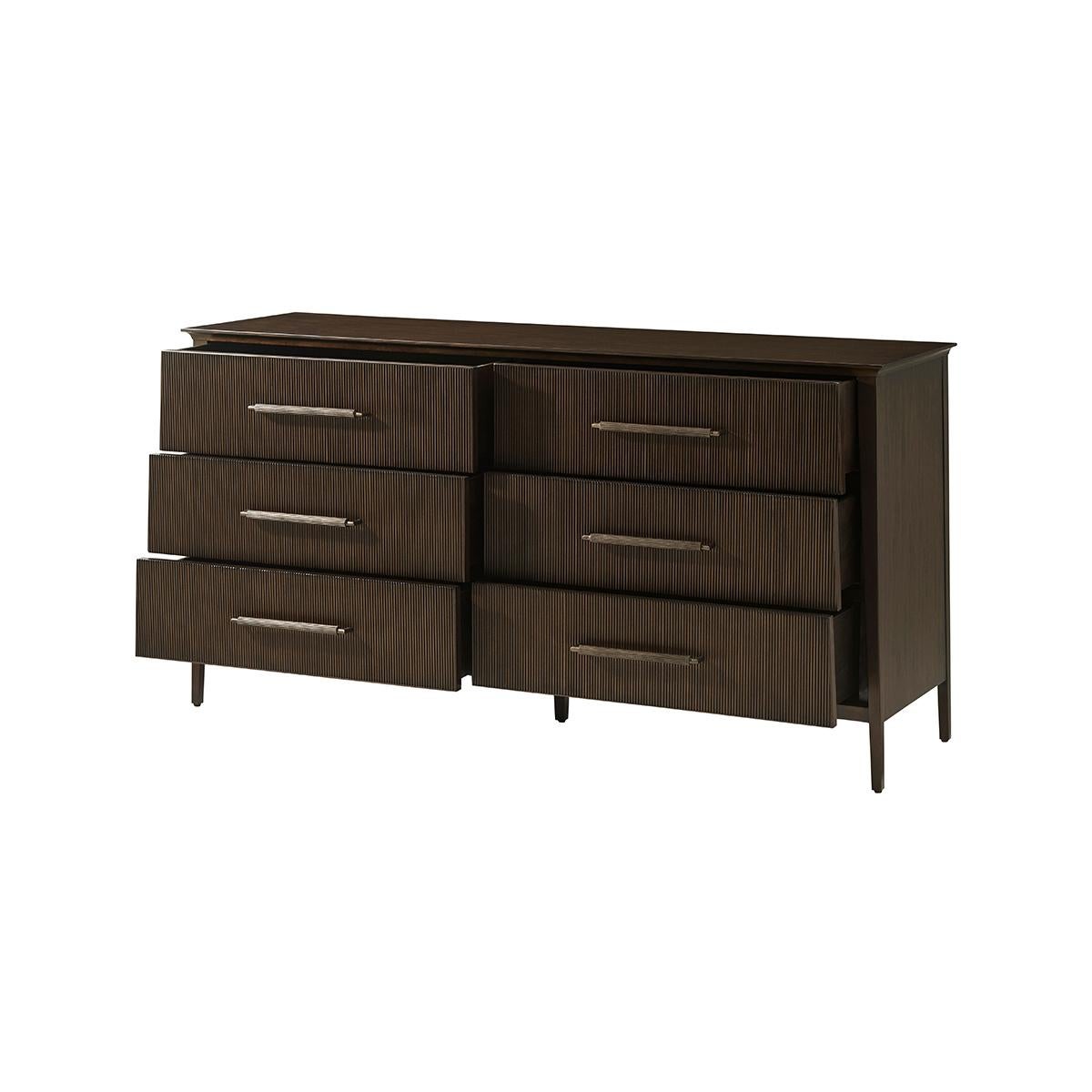 Features a sophisticated tapered silhouette with six reeded drawer fronts. The custom forged hardware, finished in a dark rubbed bronze, echoes the reeded details throughout.

Dimensions: 65
