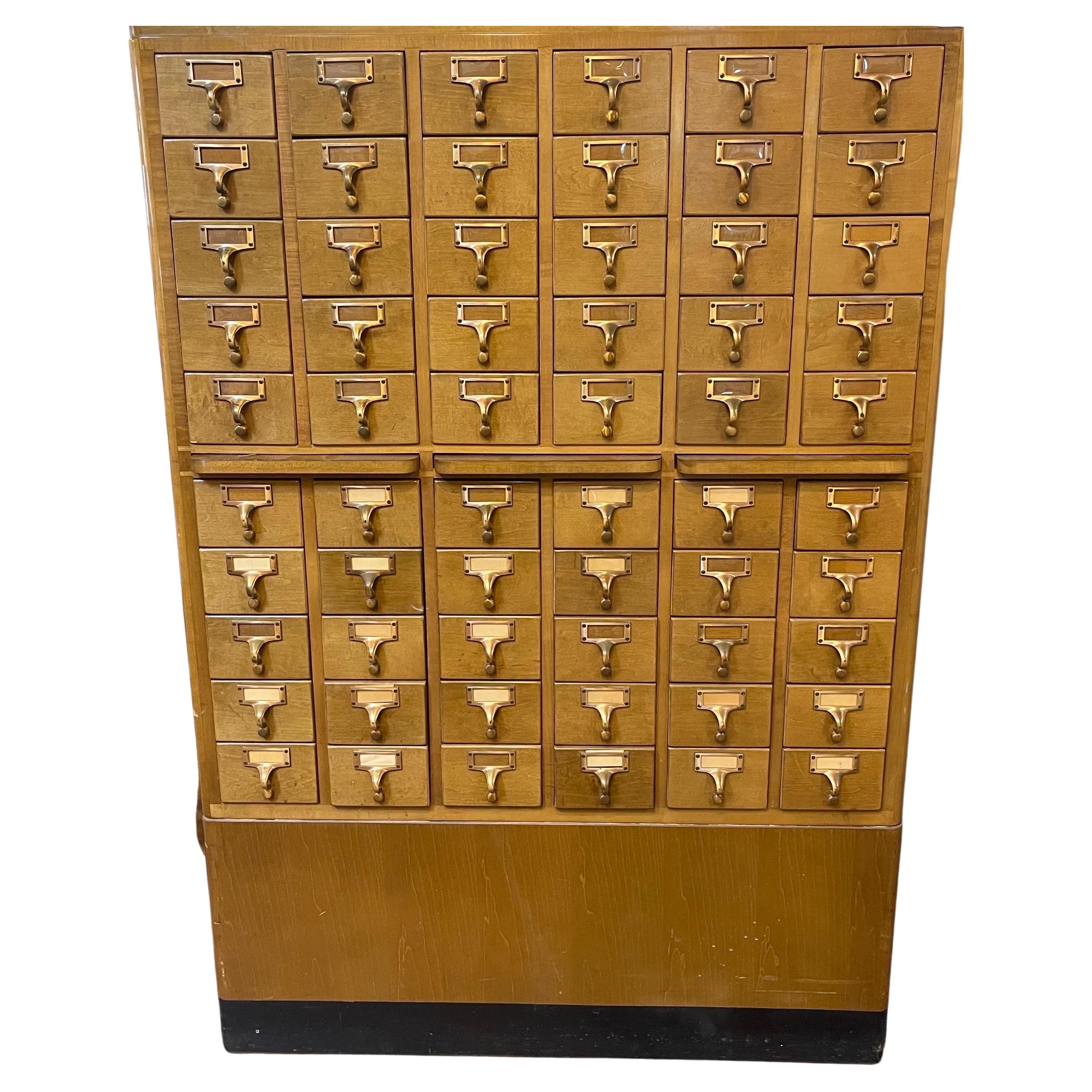 A very nice sixty drawer library card catalog in blond wood (maple?) by Gaylord Brothers, circa 1960s. The piece is in very good vintage condition and finished on all sides with brass hardware pulls. It measures approximately 36