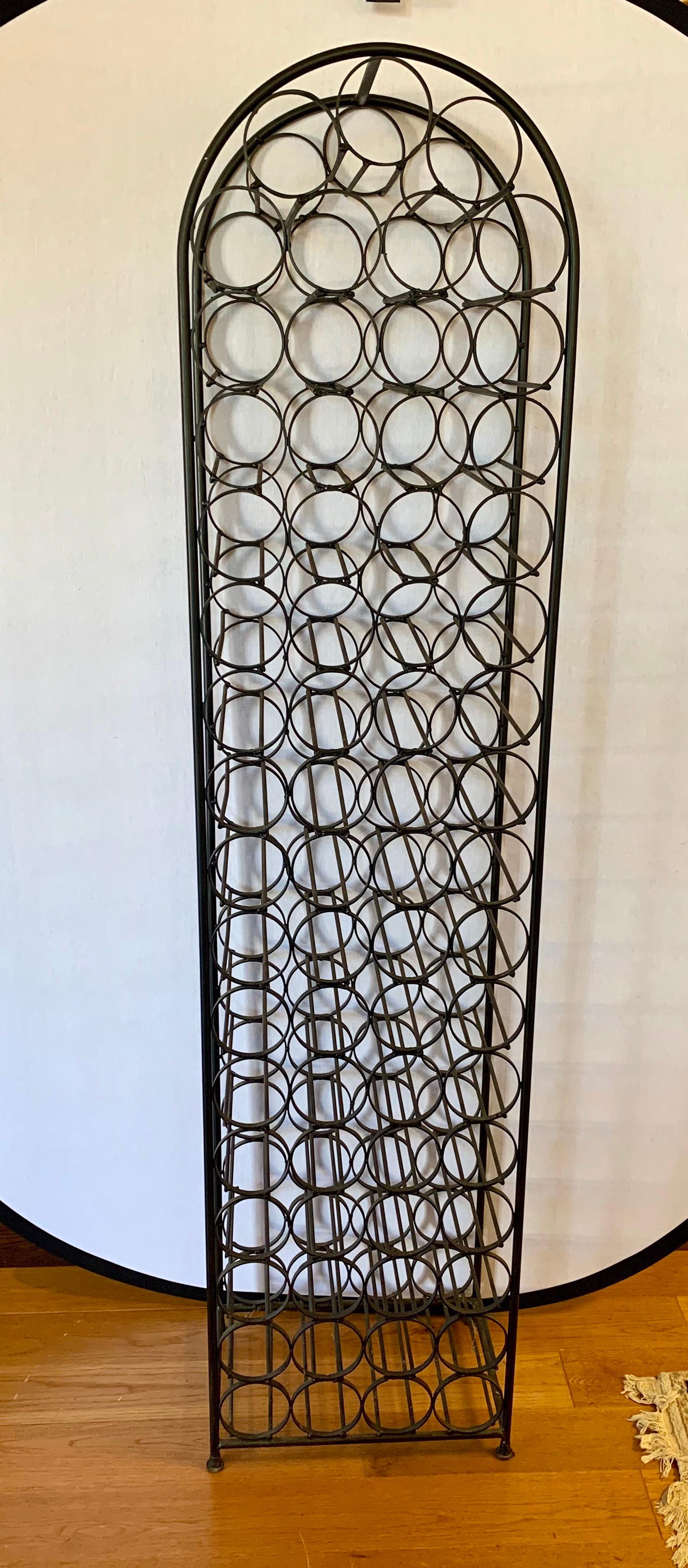 Vintage sixty seven bottle wine rack with semicircle top. Made of wrought iron.