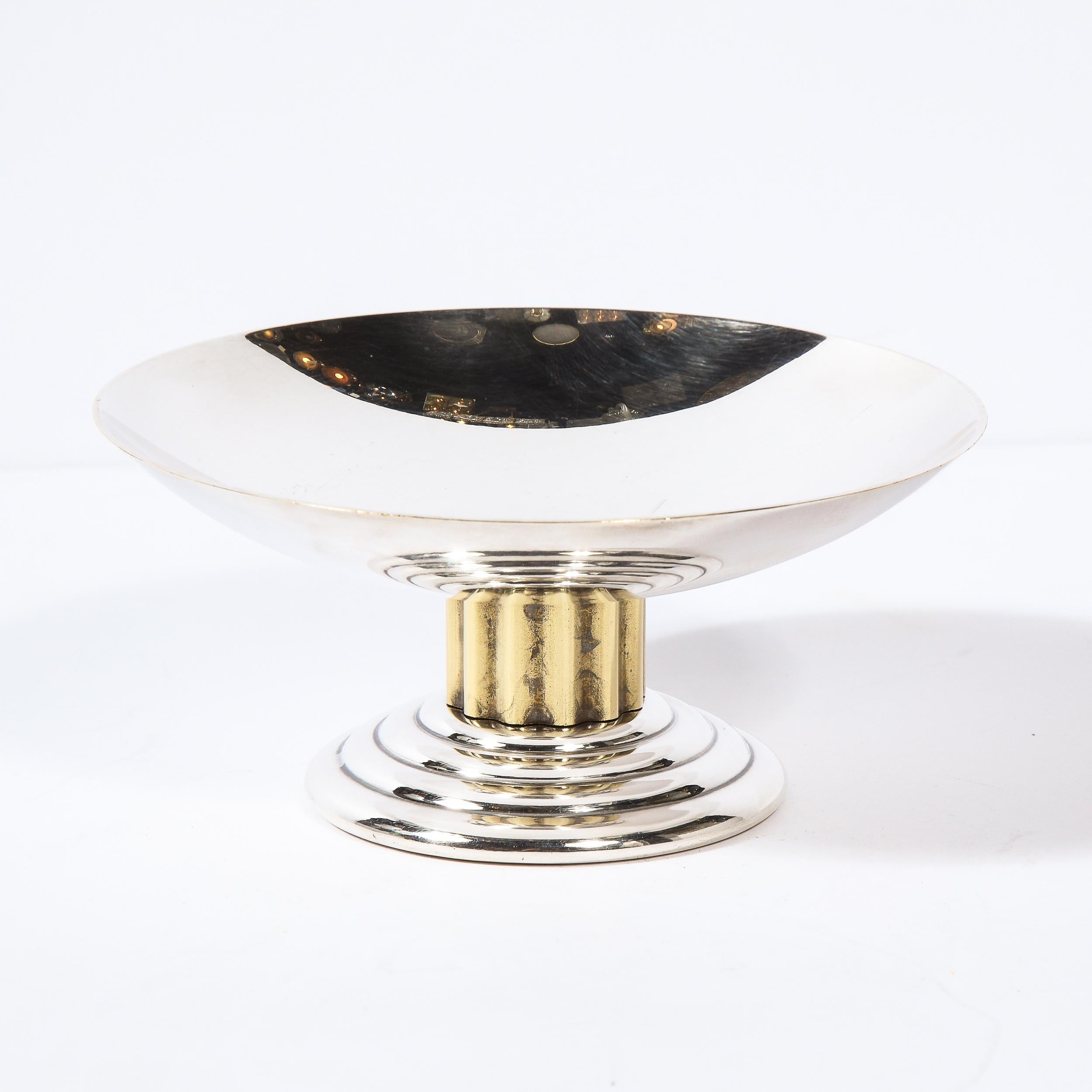 This stunning Art Deco silverplate and gilt dish was realized by Puiforcat in France, circa 1960. It features a tiered skyscraper style base with a channeled gilt stem that ascends into a concave dish- perfect for holding mints, candies, flower