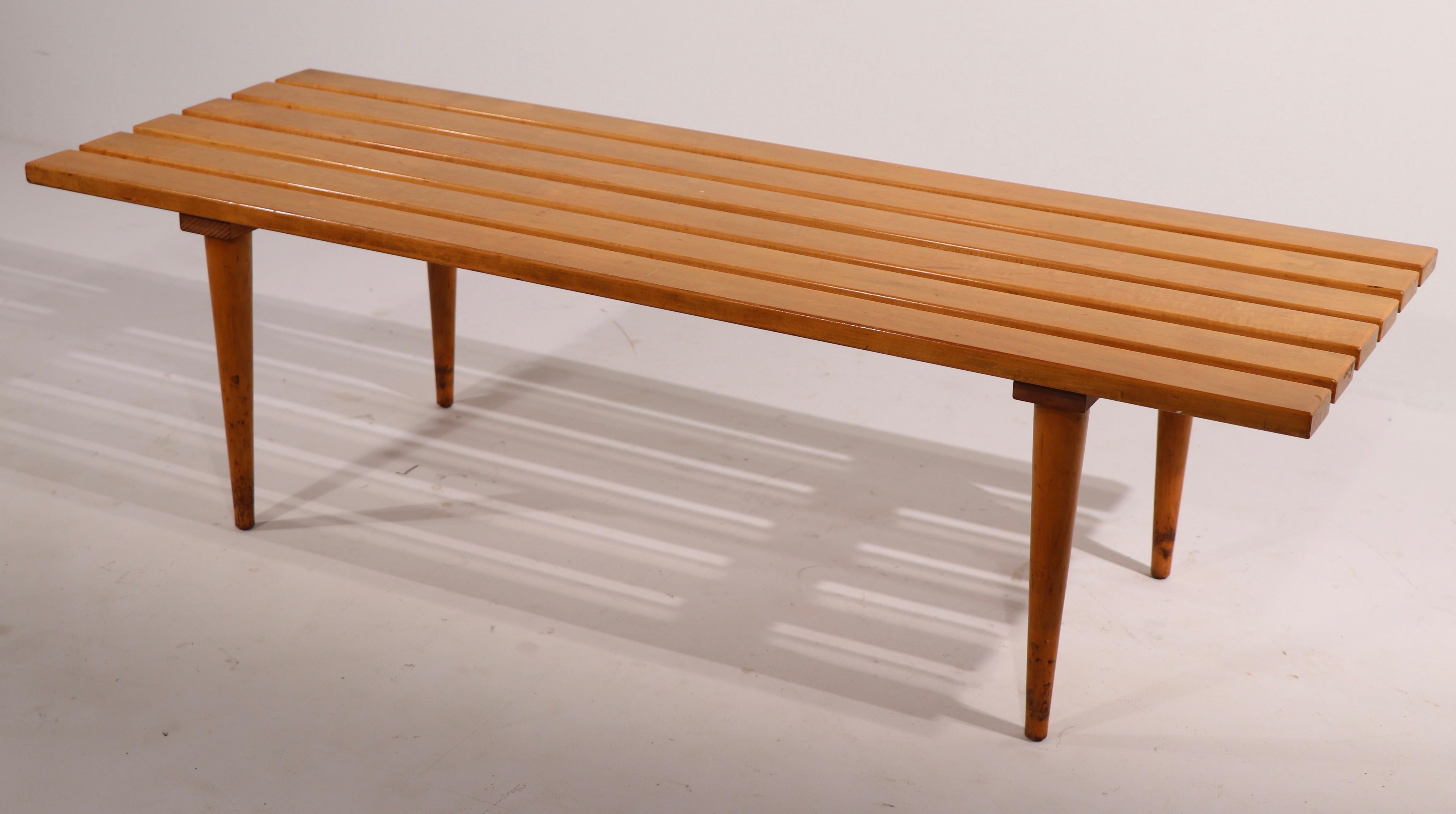 Iconic slat bench coffee table, made in Yugoslavia. This examples solid maple, unusual to see this form in the blonde finish, as most are in dark wood. Classic architectural Mid Century design, simple, chic and sophisticated. The table is in good,