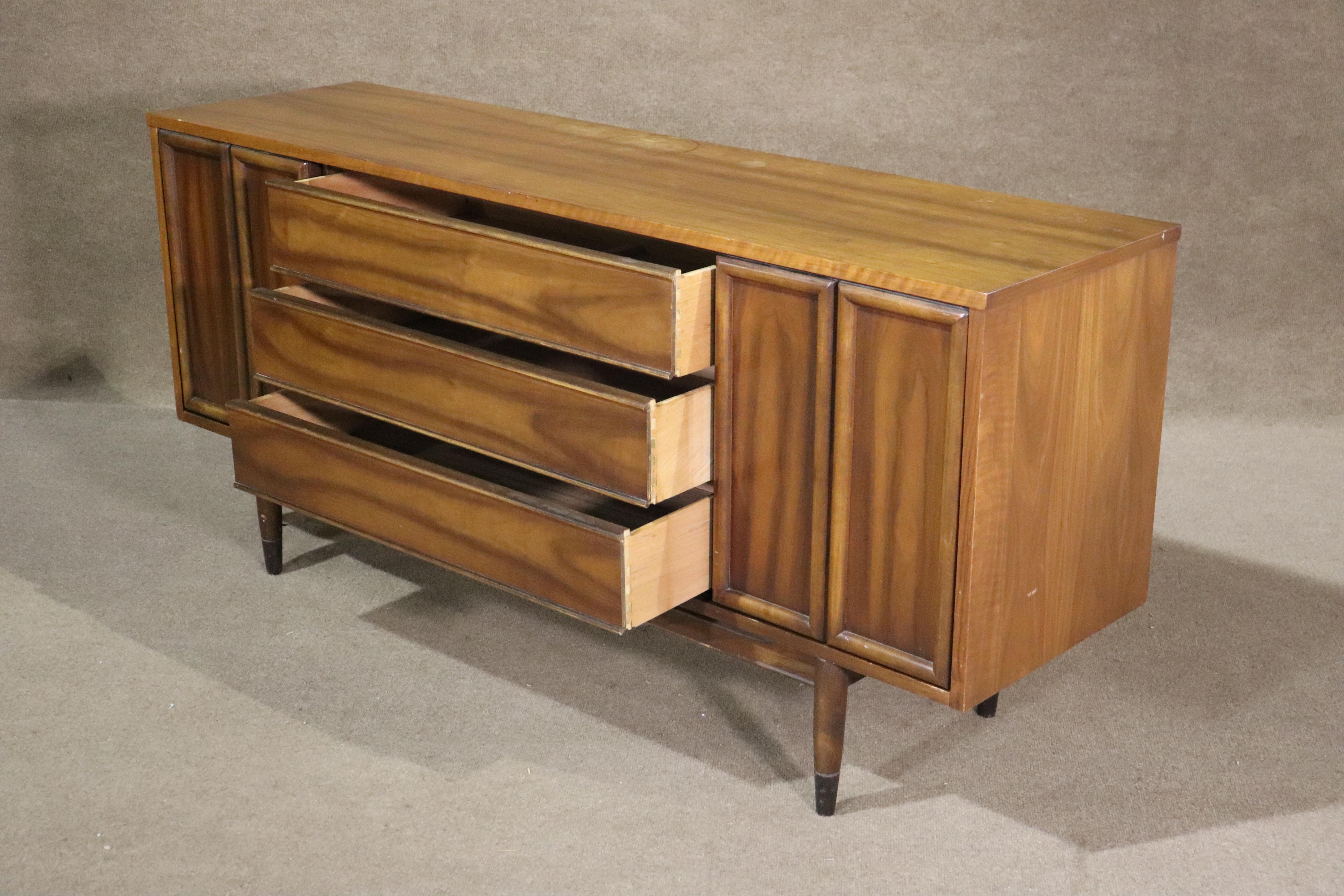 Long walnut dresser with cabinet storage. Over five feet in length, this unit has three wide drawers and two concealed cabinets for storage. Great for bedroom or living room use.
Please confirm location NY or NJ