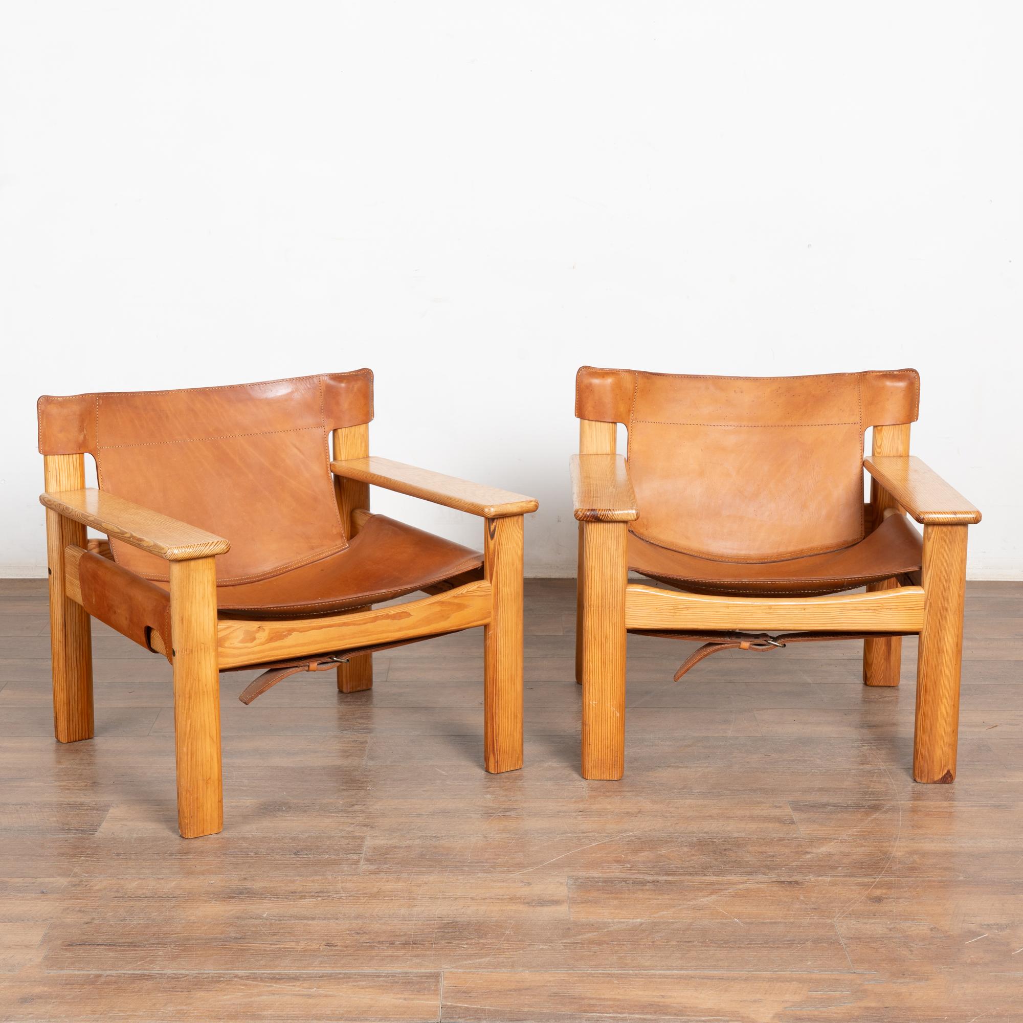 A pair of mid-century Scandinavian pine lounge chairs with full grain leather sling seat and back in camel color.
Sold in used vintage condition. Chair frames are solid and ready for use.
Condition: Vintage leather shows typical signs of age and