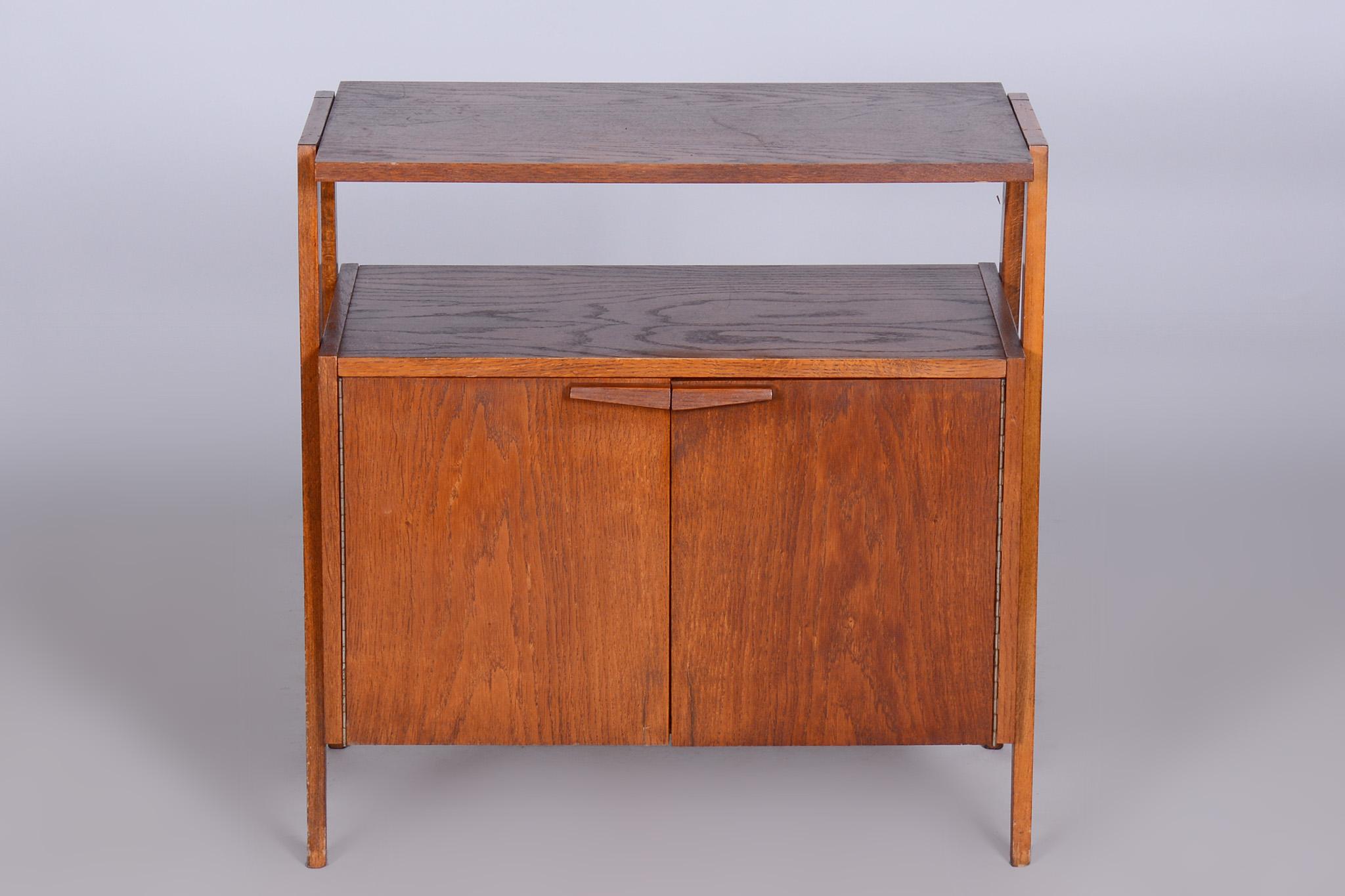 Restored midcentury small cabinet By Tatra Pravenec.

Period: 1950-1959
Maker: Tatra Pravenec
Source: Czechia
Material: Stained oak

Very well-preserved original condition. Revived polish.
 