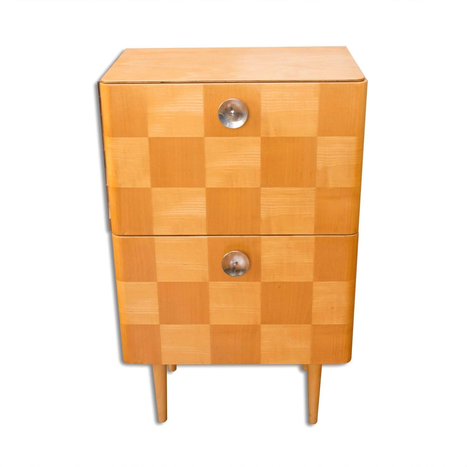 This commode or bedside table with a checkerboard pattern was made in former Czechoslovakia in the 1950s. Attribute to Jindrich Halabala. It was made of beechwood, plywood and features a chromed handles. It stands on four beech legs. The commode is