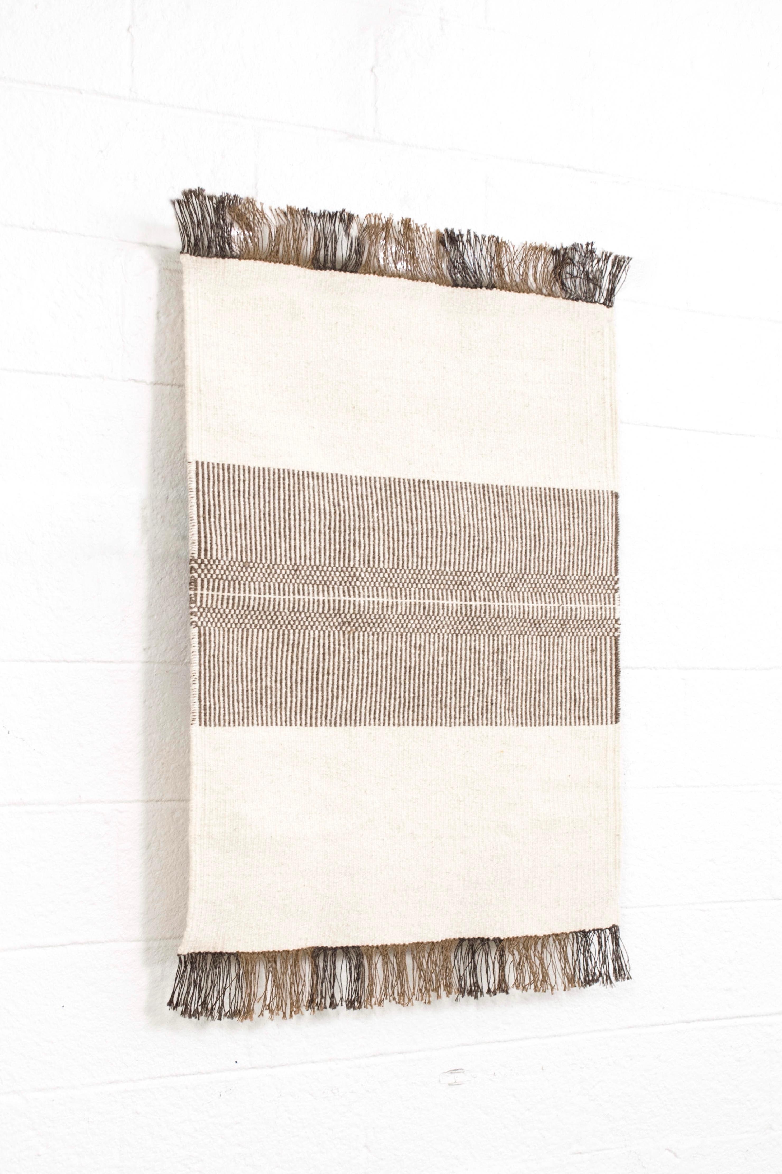 This gorgeous vintage Mid-Century Modern accent rug is exquisitely crafted from hand-loomed 100% wool in varying shades of natural medium brown and features a simple, clean, Minimalist design. Use as an floor accent rug or wall hanging.

Additional
