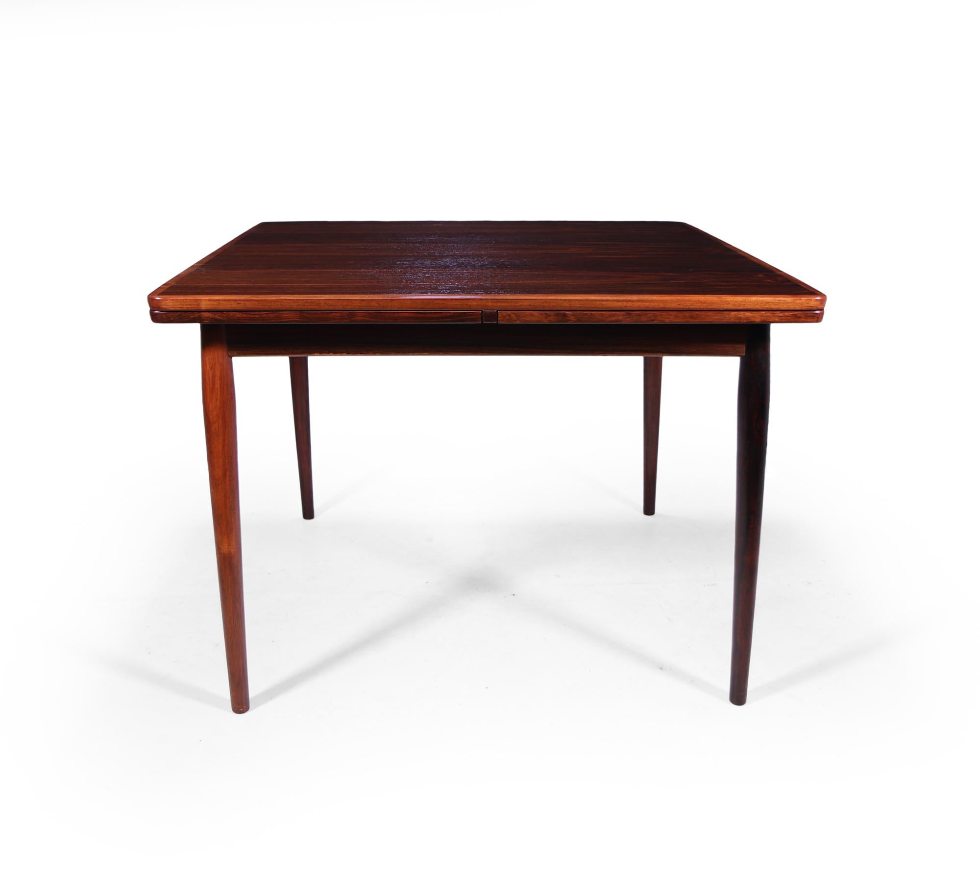 A stunning quality mid century dining table designed by Arne Vodder and produced by Sibast in Denmark in the 1950’s, this is the small version of the two sizes that were produced it starts as square seating 4 and extends to seat max 8.

The leaves