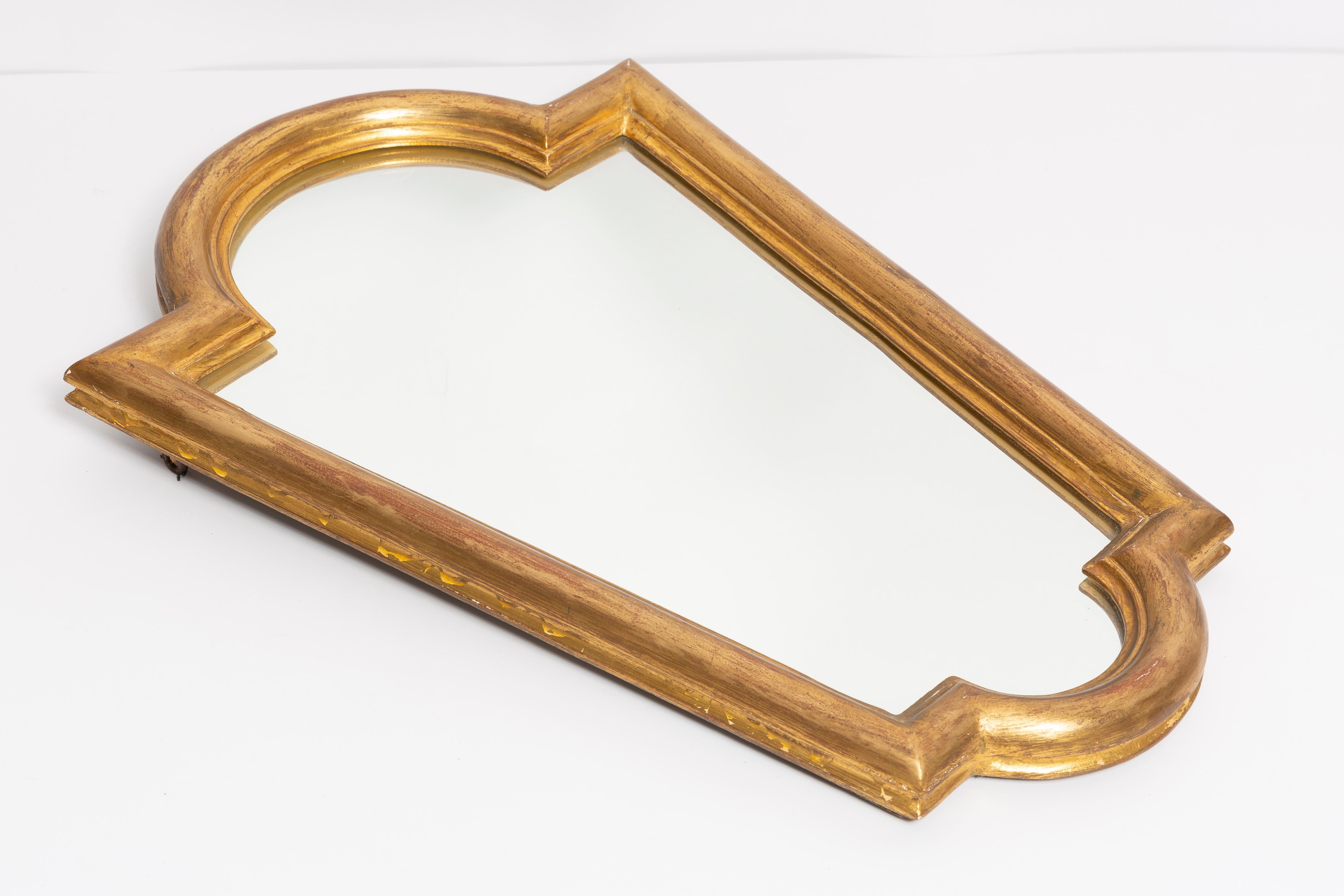A medium mirror in a golden decorative frame from Italy. The frame is made of wood. Mirror is in very good vintage condition, no damage or cracks in the frame. Original glass. Beautiful piece for every interior! Only one unique piece.