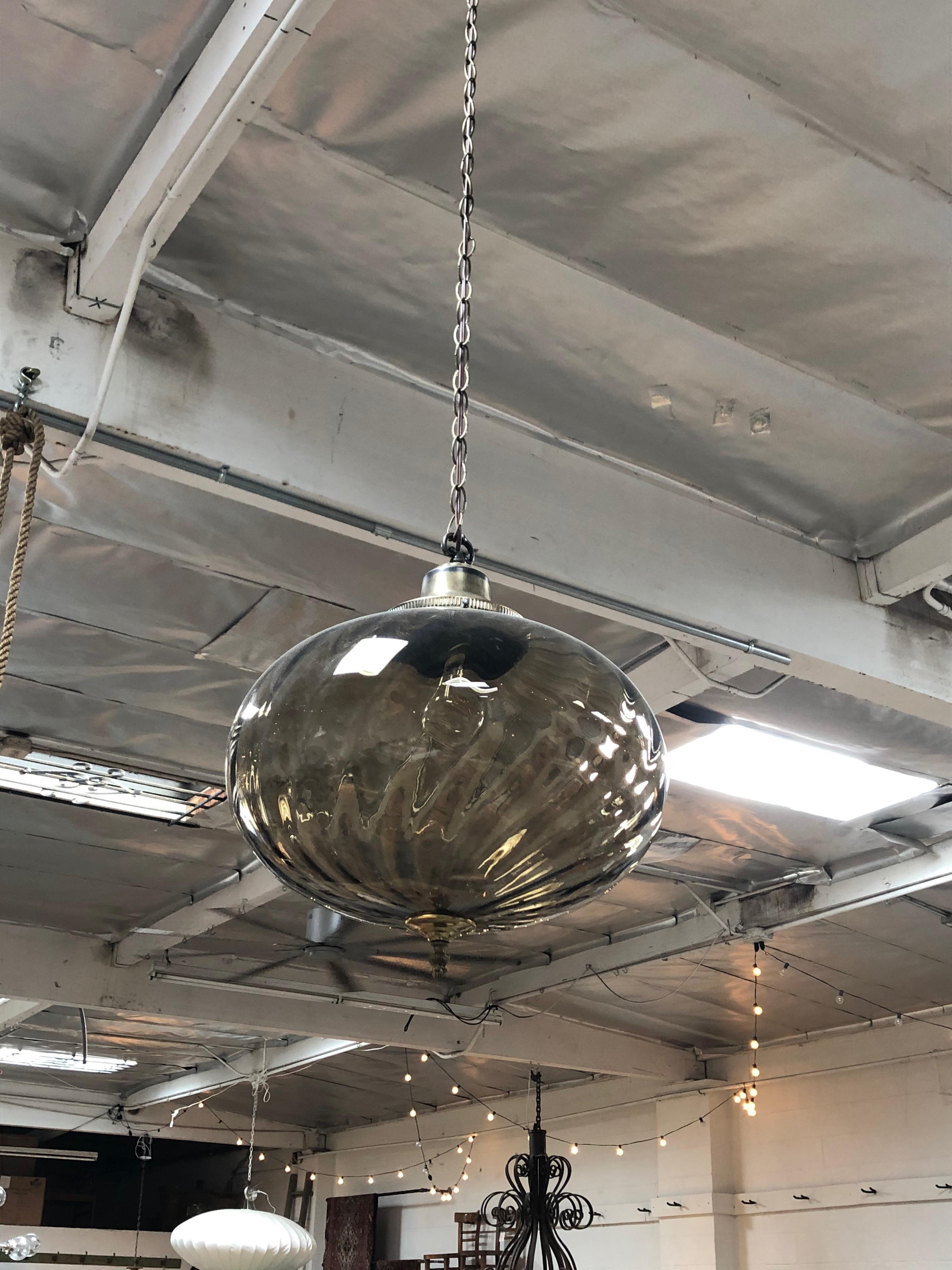 This glass pendant is a round lighting fixture with a beautiful smokey color. 

 