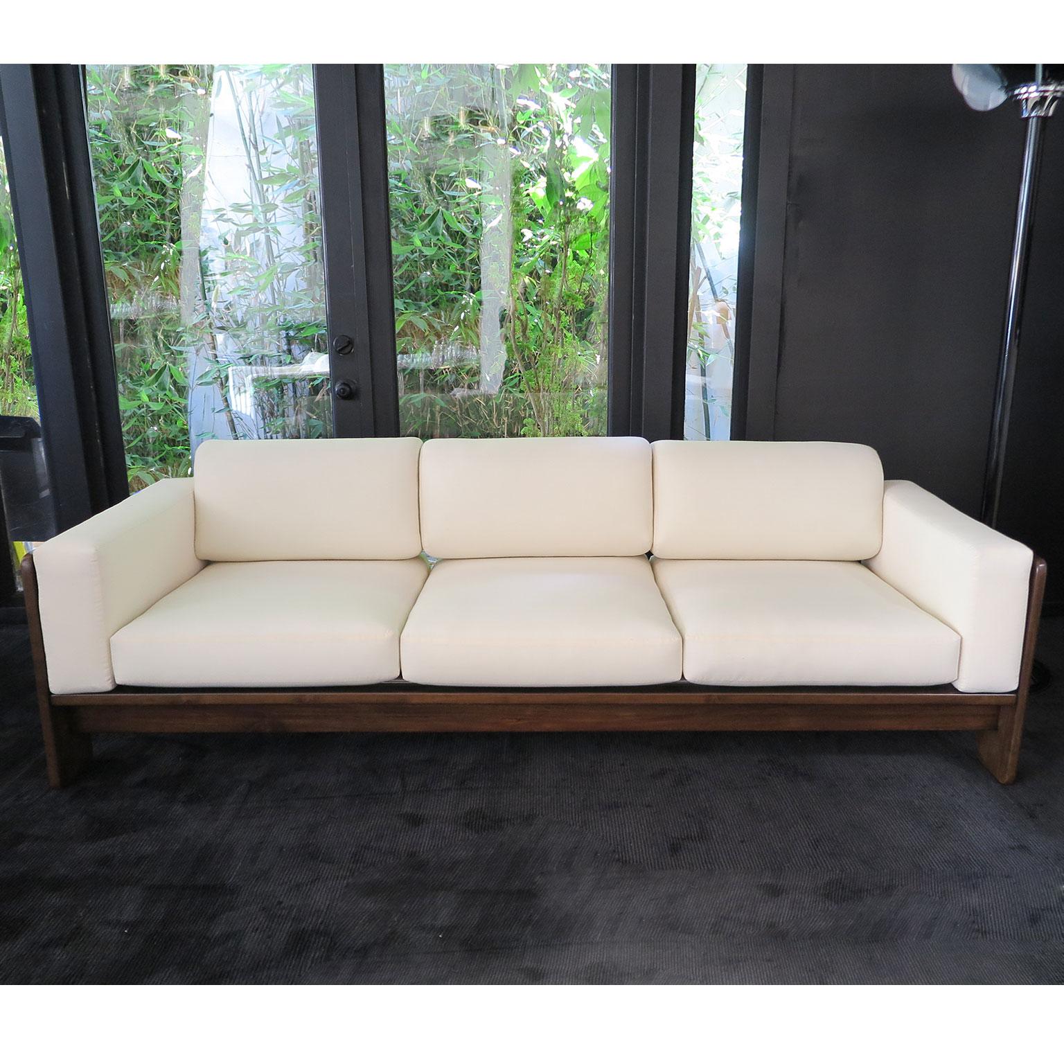 Midcentury, wooden three-seat sofa with thin frame in a matte finish. Newly upholstered in muslin for custom fabric or leather. 
