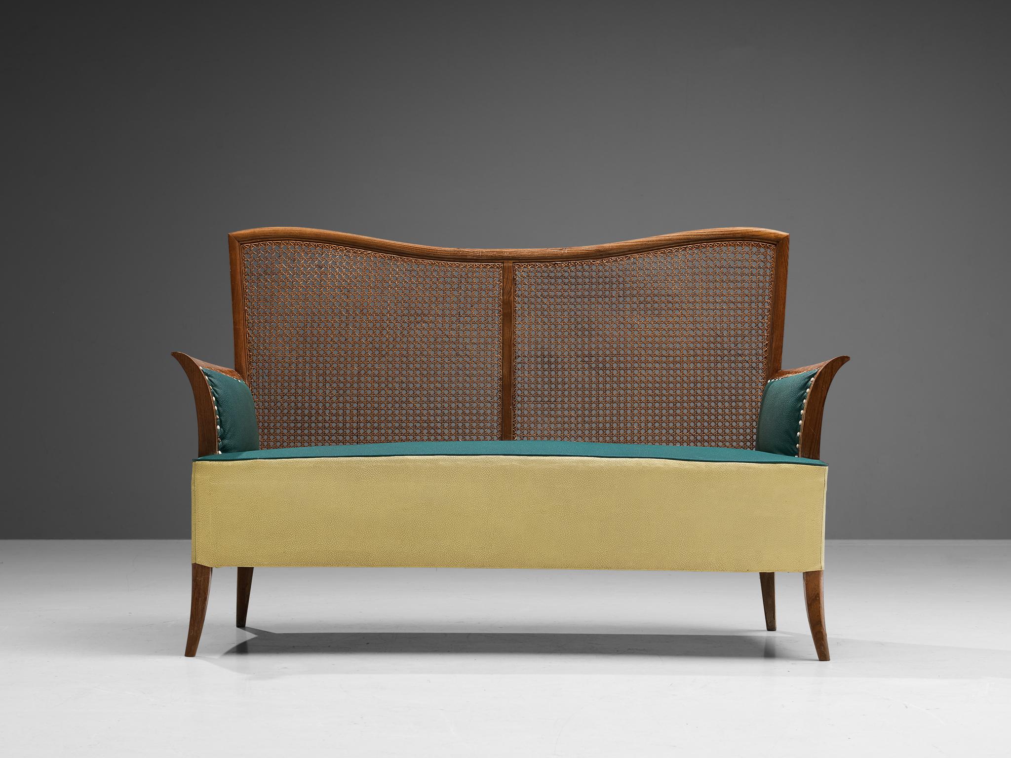Settee, ash, cane, leatherette, metal, Spain, 1950s. 

Joyful Spanish two-seater sofa with soft organic lines. This settee features a stained ash frame of which a dynamic grain pattern comes through. The backrest is made of woven cane that shows a