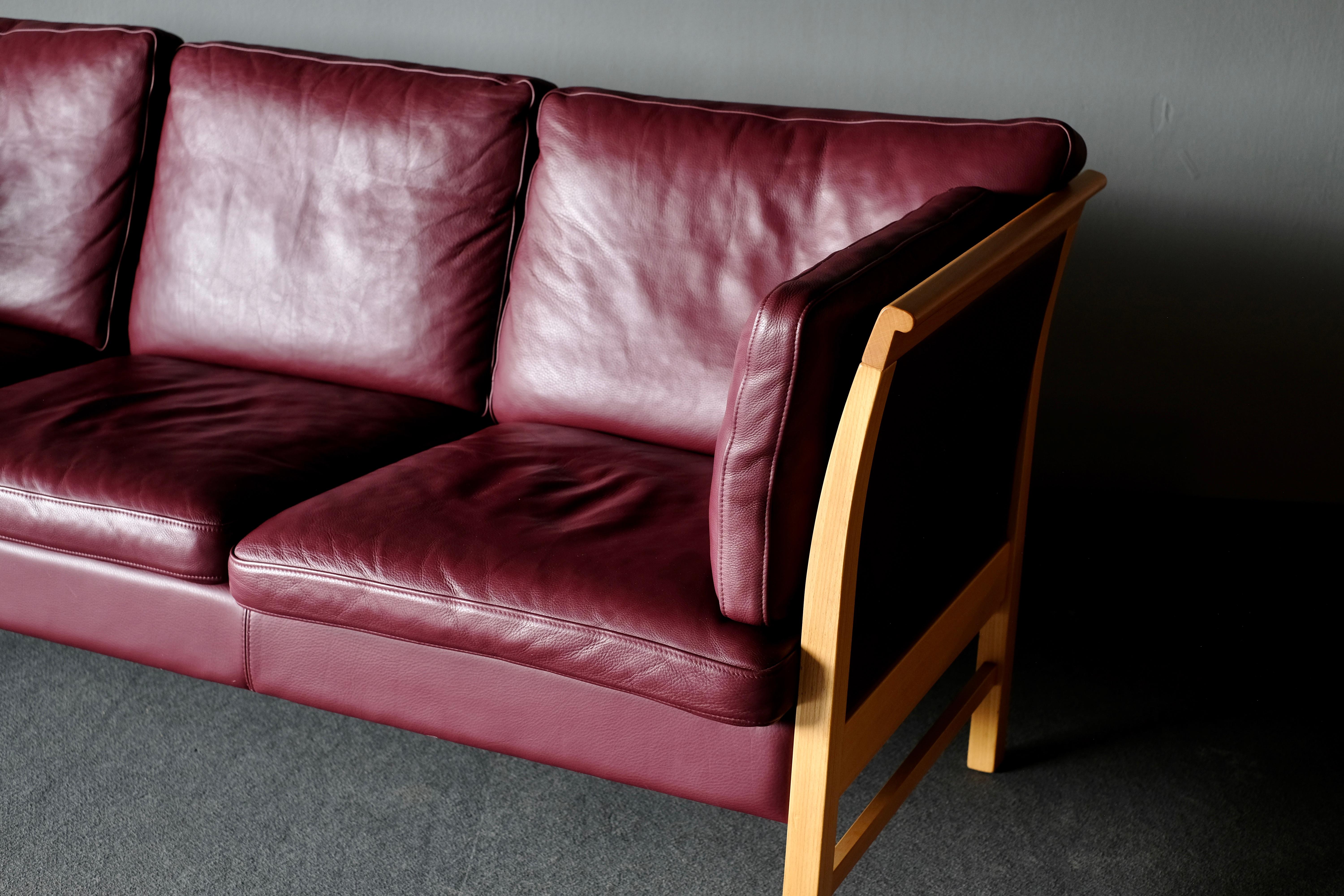 Generously proportioned 3-seat sofa with loose cushions upholstered in leather.
