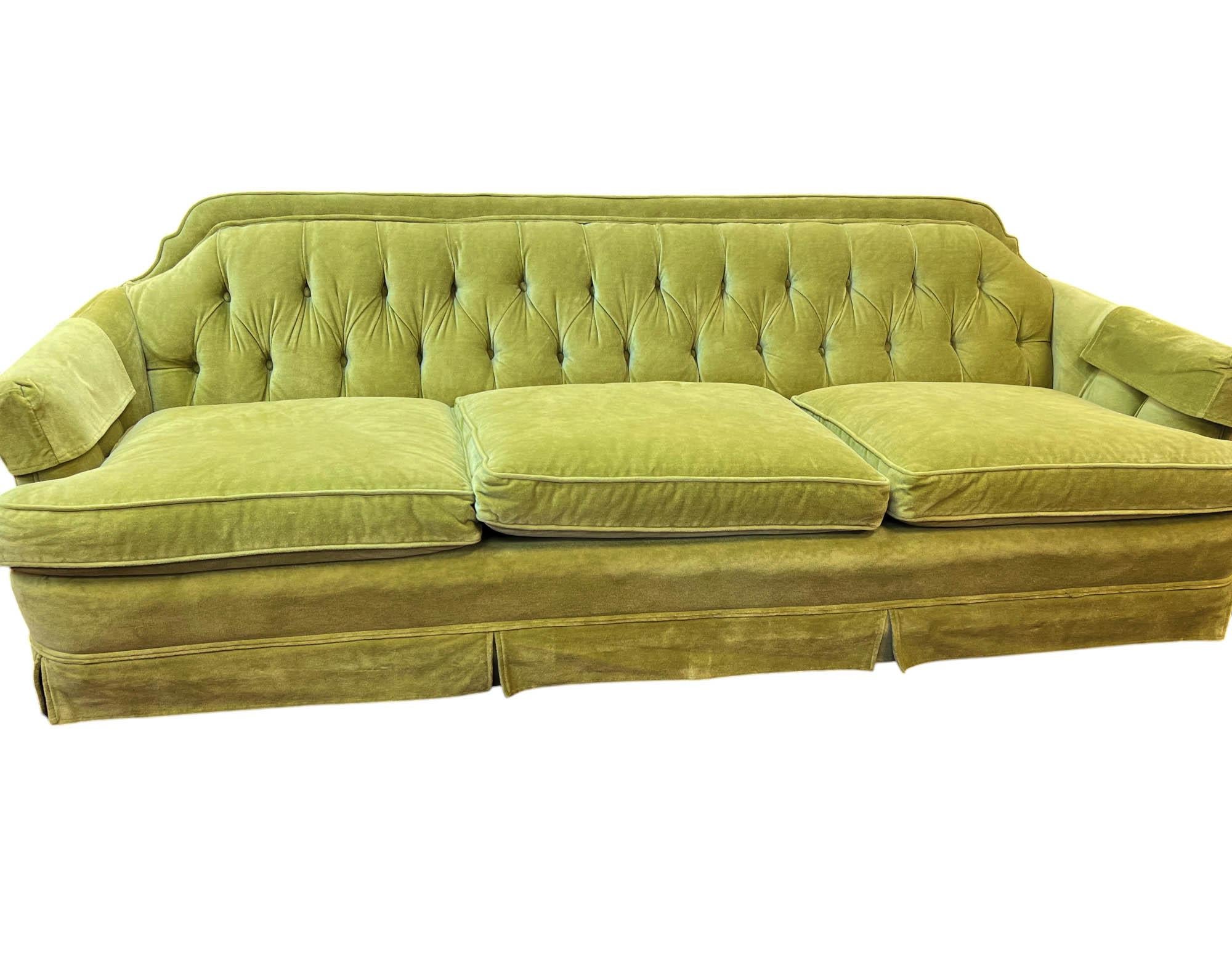 Ein klassisches Mid-Century-Sofa mit drei Sitzen, gepolstert mit plüschigem chartreusefarbenem Samt, der sowohl eine kräftige Farbe als auch eine reiche Textur bietet. Der Rücken wird durch eine gewölbte Rückenlehne mit Knopfleiste definiert, die