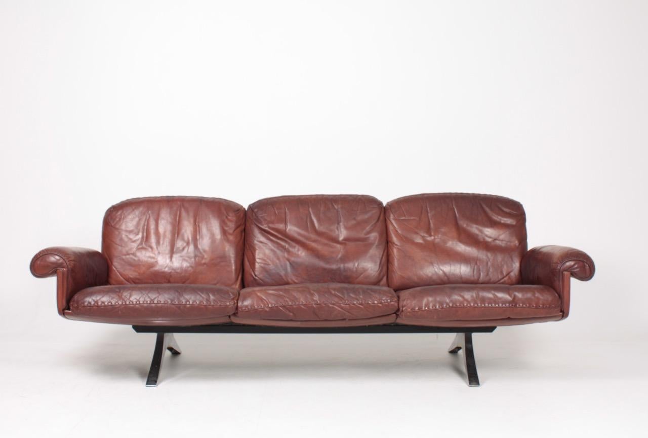 Great looking and very comfortable three-seat sofa in patinated leather. Designed and made by De Sede in Switzerland, 1960s. Great original condition.