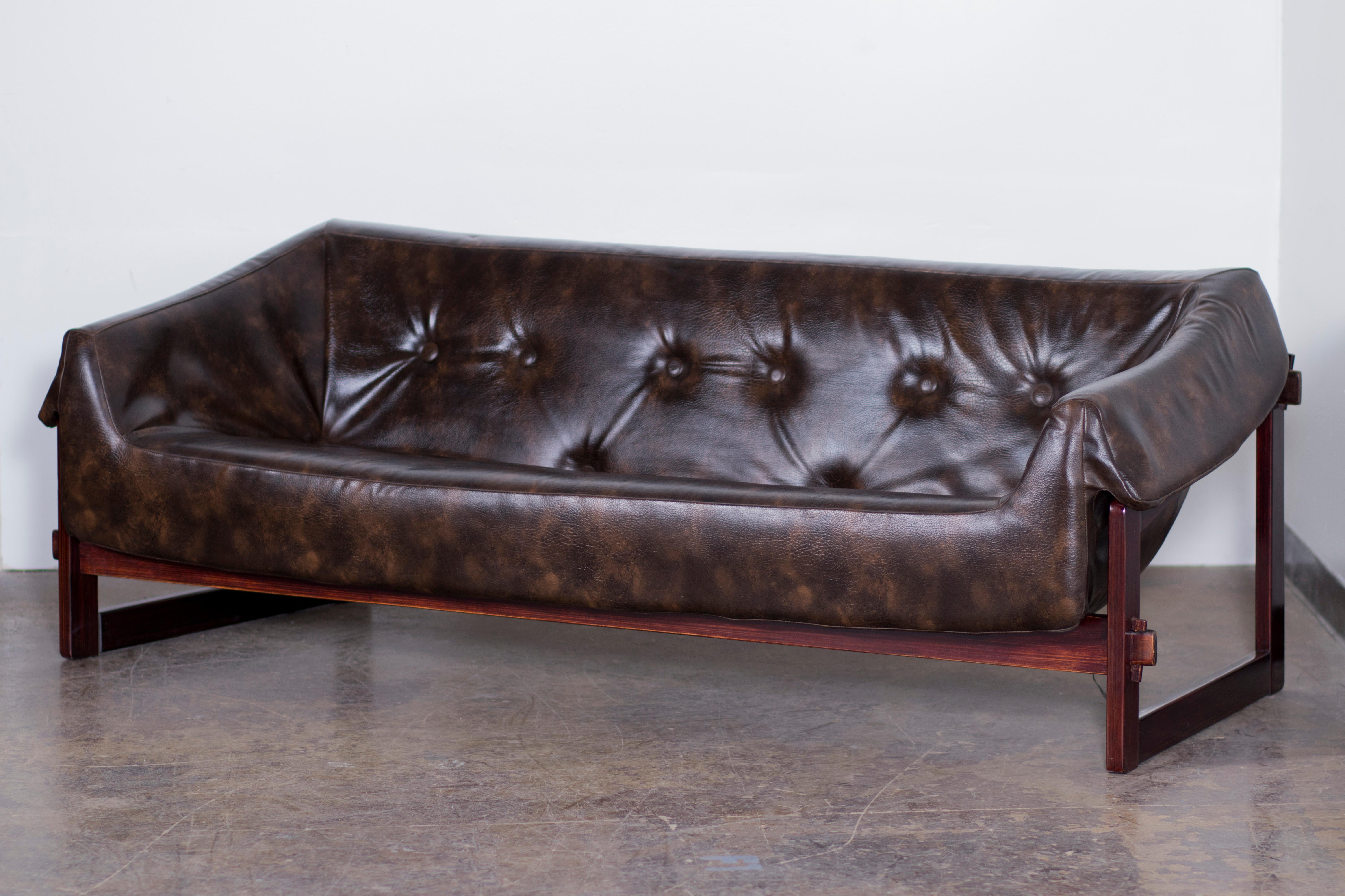 Mid-Century Modern sofa by Percival Lafer in Brazilian Cherry and original rare vintage leather. Really unique design and construction make this a true statement piece.