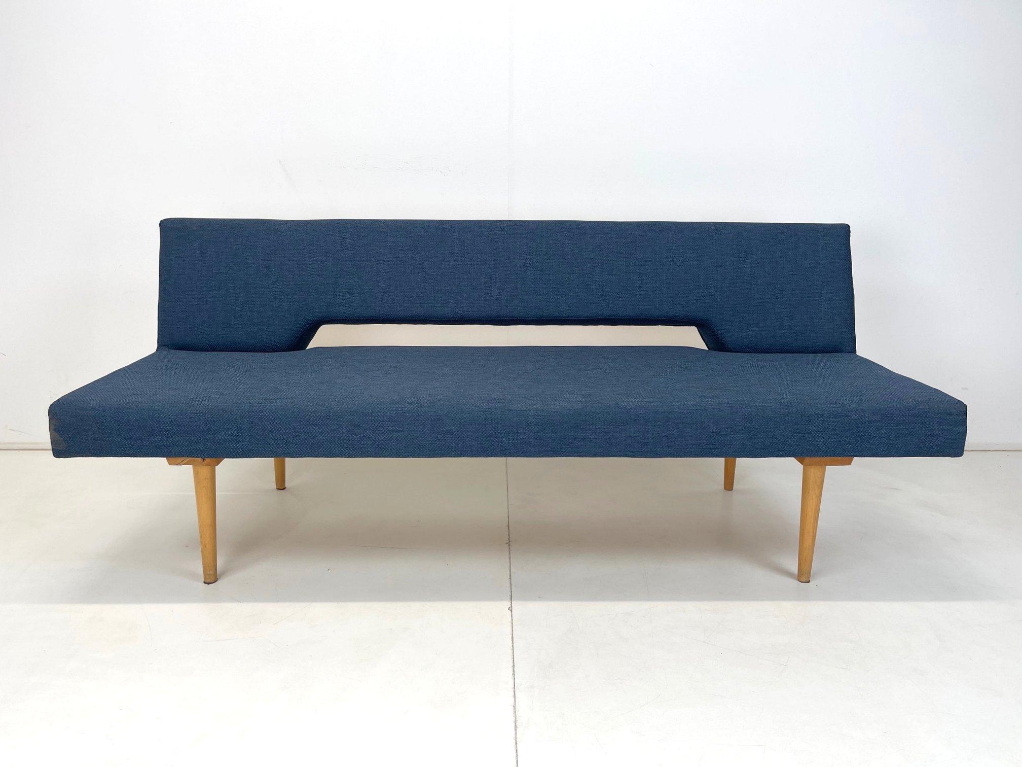 Iconic model by Interier Praha, produced in the 1960's. When unfolded, the bed measures 186 cm in width. Newly upholstered.