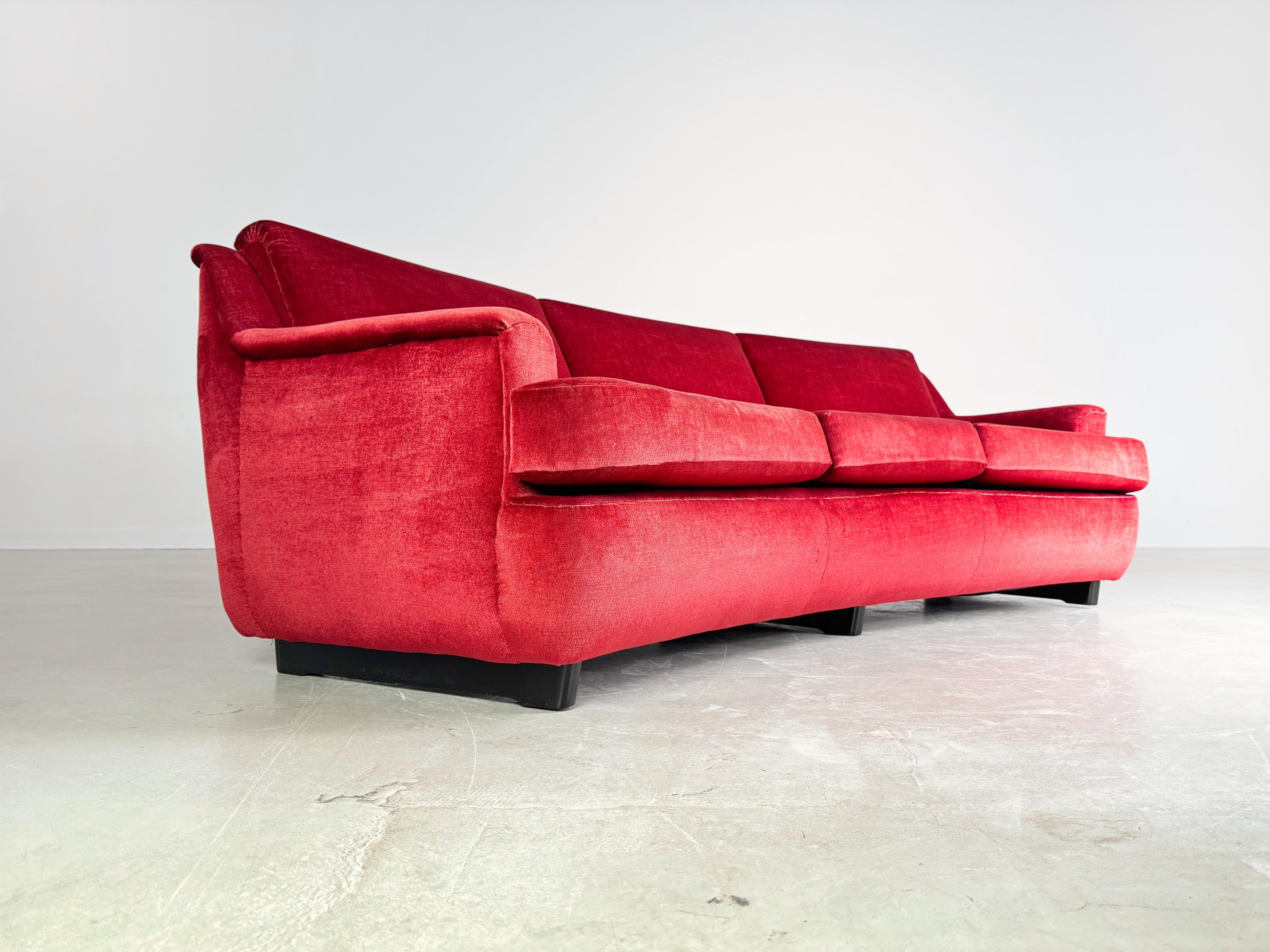 We are offering a beautiful vintage couch from the 1960s for sale. The sofa is covered with a red velvet fabric, which gives the furniture a special 1960s/1970s charm. The cover was renewed at the end of the 1990s and has been protected from