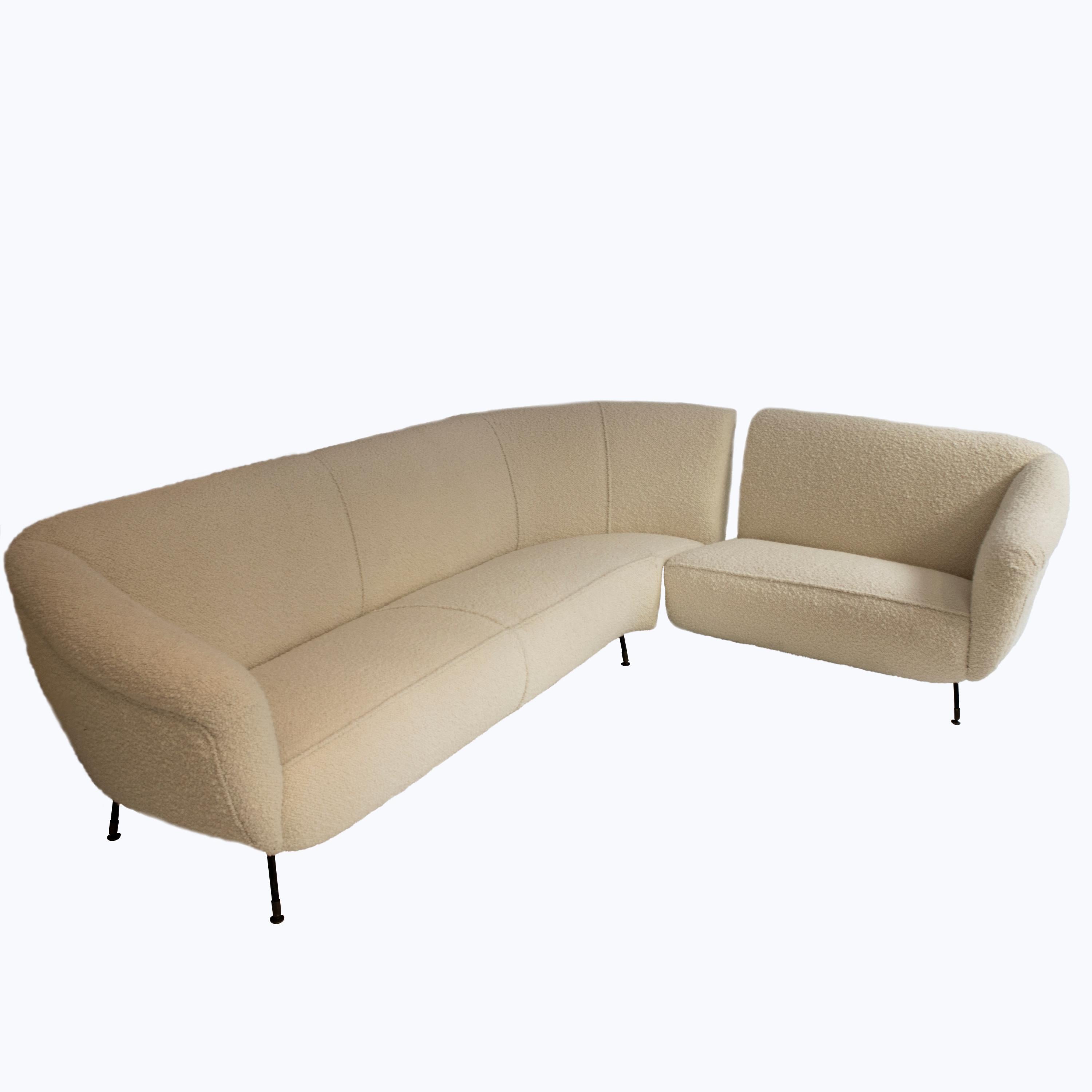 An L-shaped corner sofa with a wooden structure and a metal base, reupholstered in wool Buclé, Italy, 1950s. The Sofa consists of two connected pieces and metal legs.