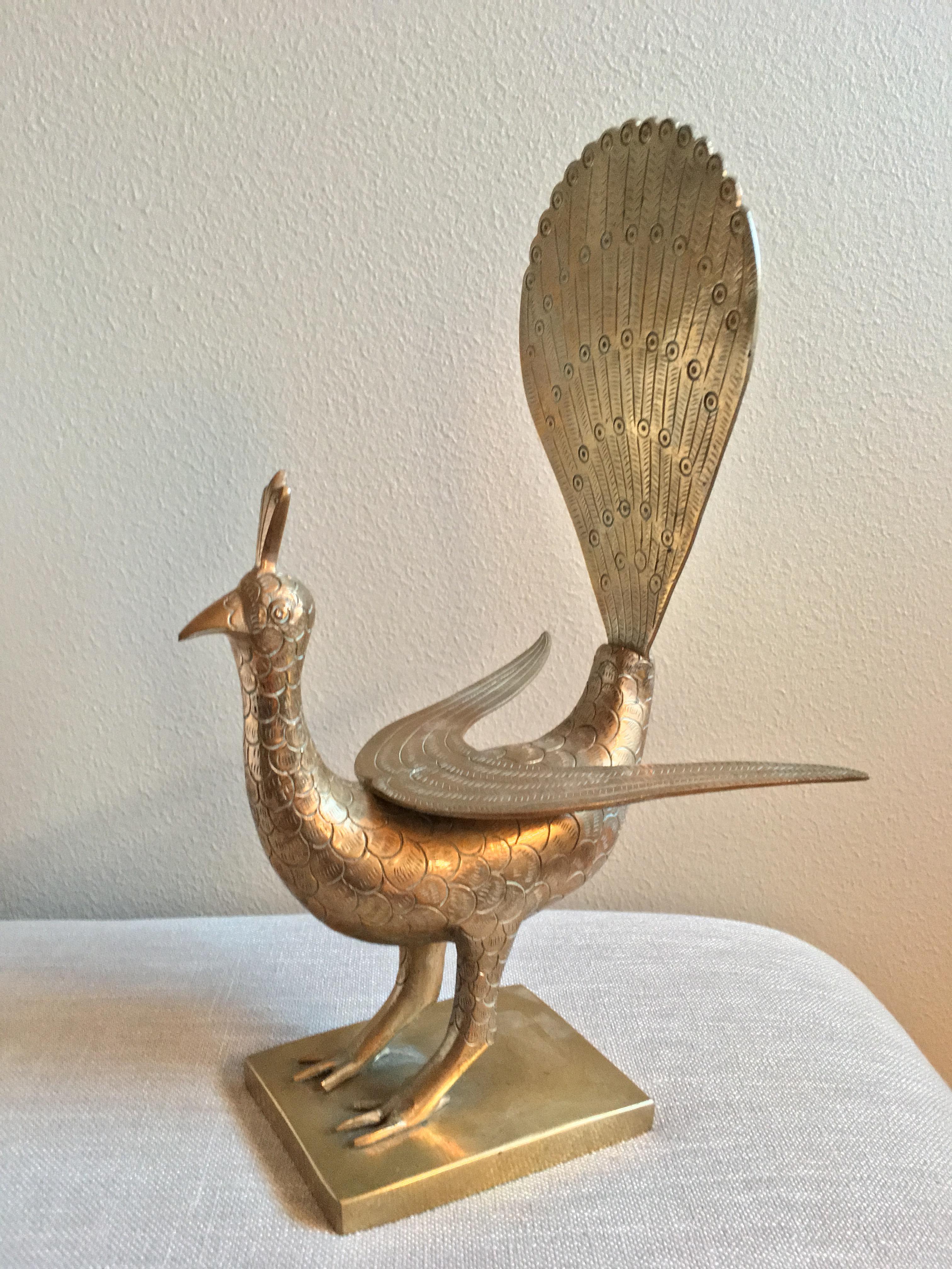 One-of-a-kind solid-brass peacock with definite mid-20th-century style, and a bit of attitude to go along! This piece is hand-carved and richly detailed. It is well-balanced, well-weighted, and structurally sturdy. The images show the rich luster of