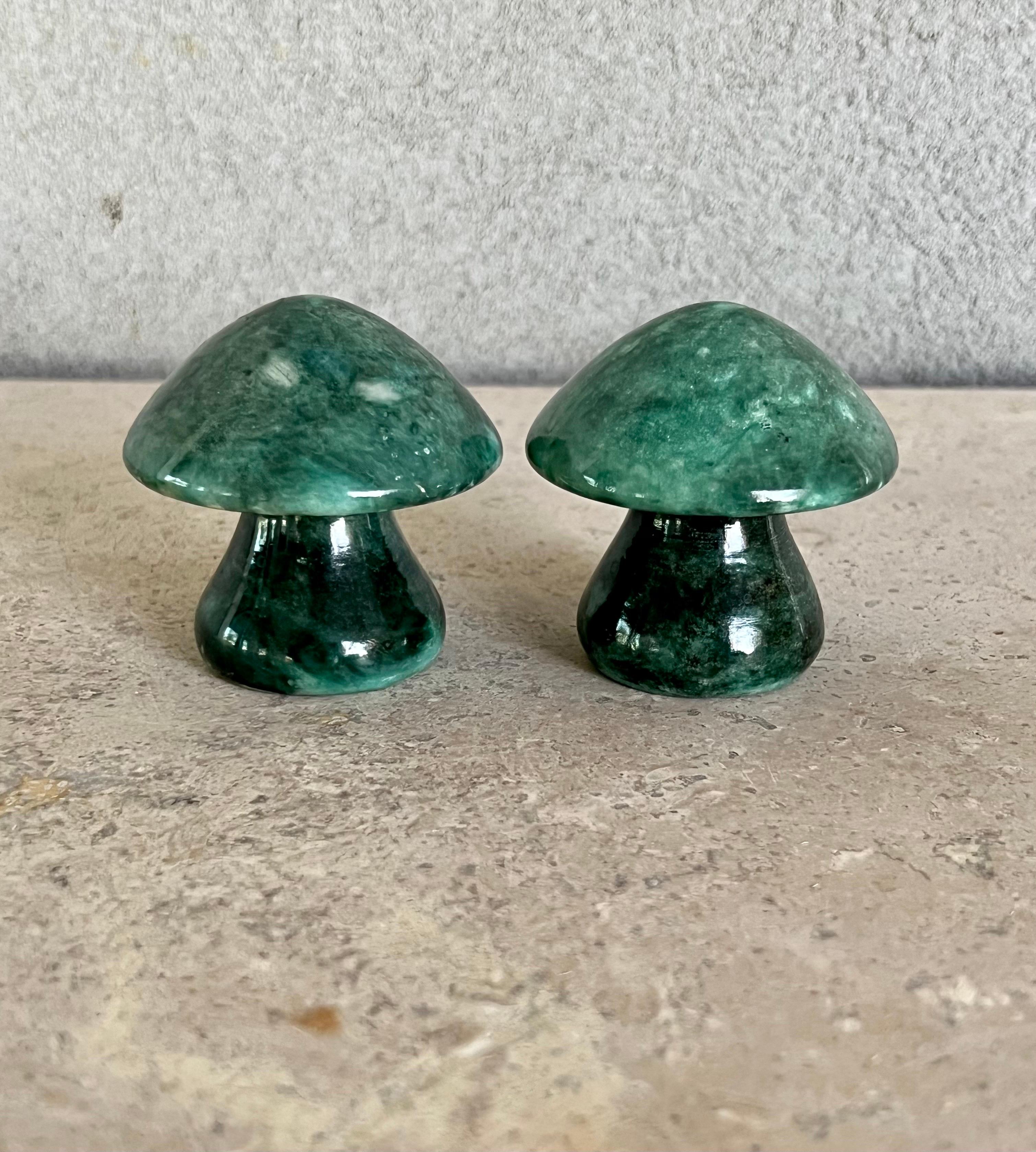 Beautiful pair of mid-century hand carved solid Alabaster mushrooms made in Italy, they have a deep polished green color, and a nice weight to them. Would be perfect as paperweights or to style a bookcase. Would also be a great Holiday gift for a