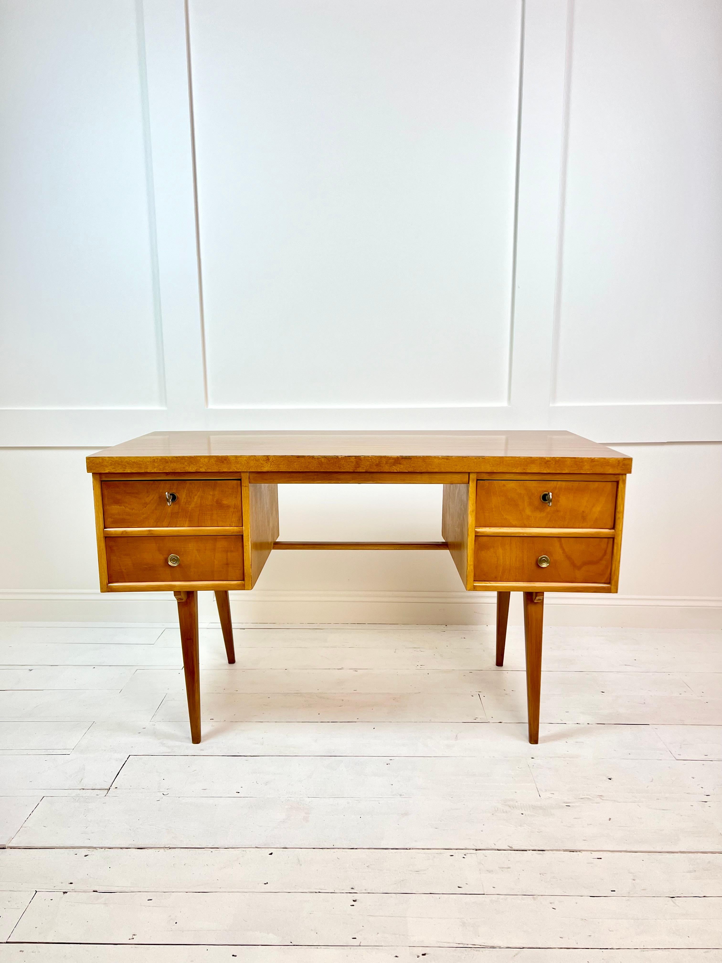  An unusual style Mid-Century Modern, solid Beech & veneer desk, crafted by Ekawerk Horn-Lippe in East Germany in the 1960's. This inventive design piece features sleek lines and a beautiful combination of solid beech wood and veneer construction,