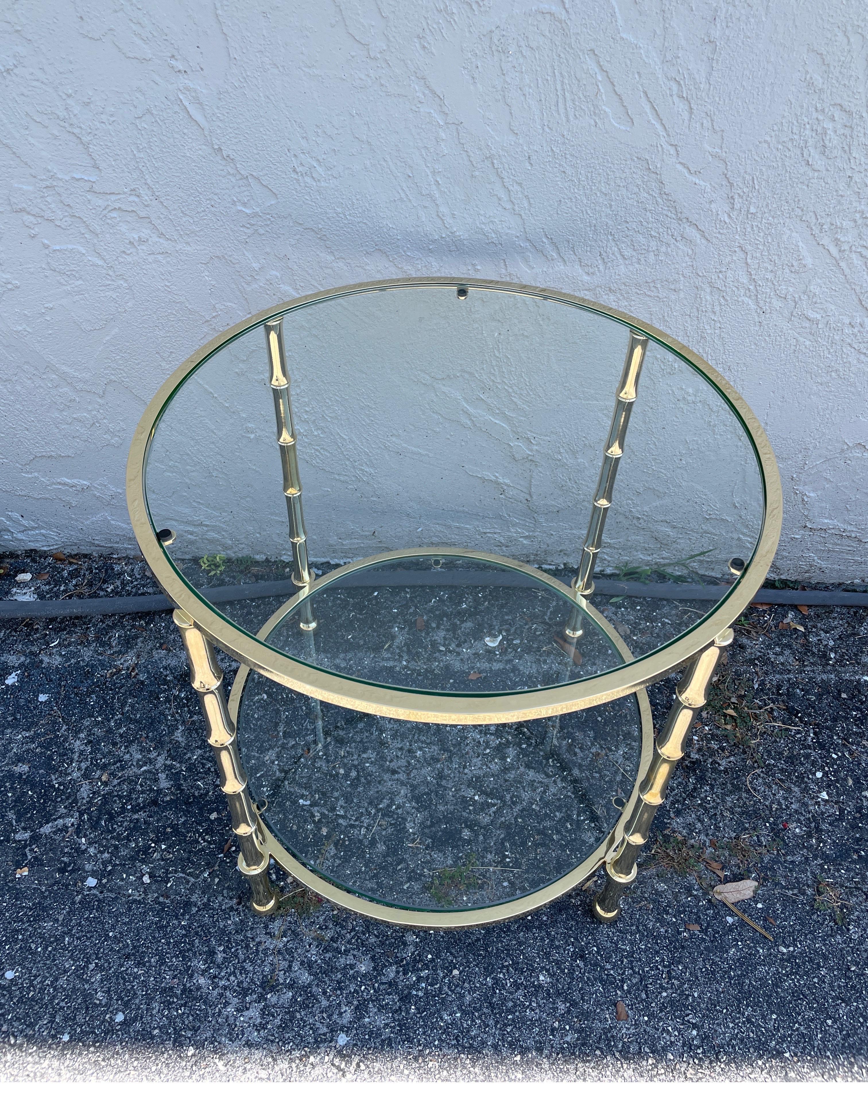 Two tier solid brass faux bamboo side table with two glass shelves.