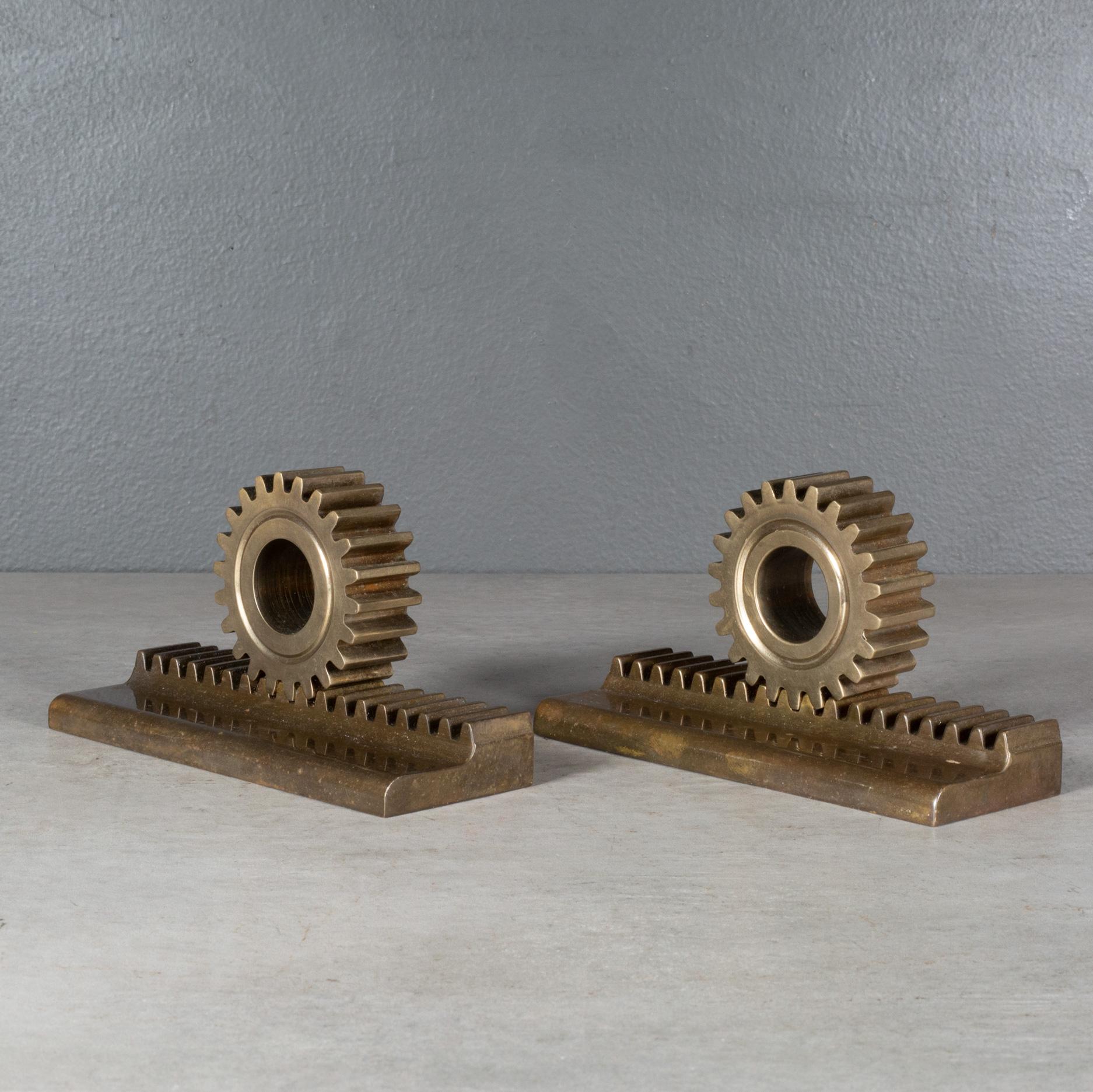 ABOUT

A pair of solid bronze gear bookends.

    CREATOR Unknown.
    DATE OF MANUFACTURE c.1960-1970.
    MATERIALS AND TECHNIQUES Solid Bronze.
    CONDITION Good. Wear consistent with age and use.
    DIMENSIONS H 3 in. W 5.75 in. D 2