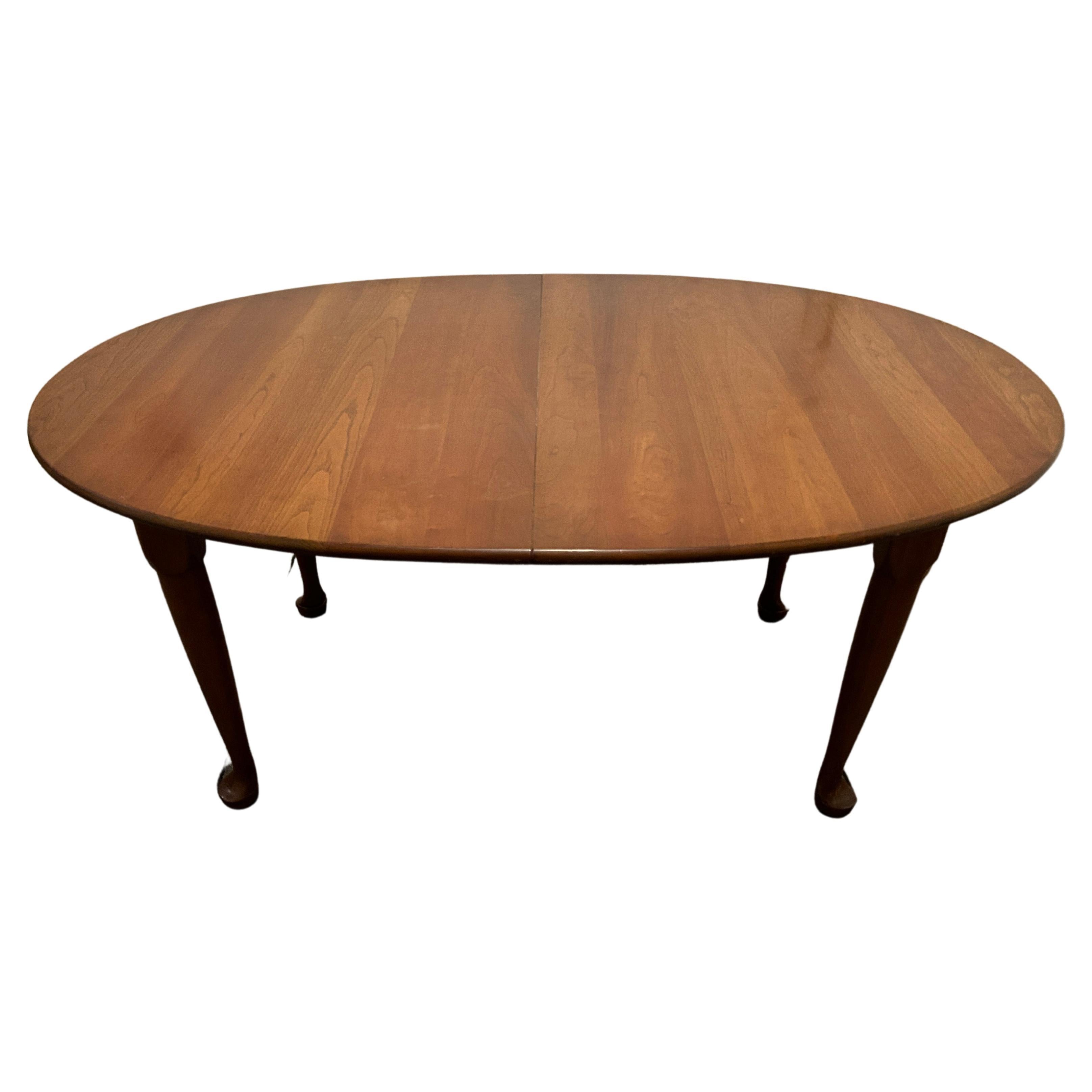 Beautiful Solid cherry dining table with 2 leaves by Stickley. Very good vintage condition - super solid Dining table. Classic oval design with 2x Leaves that match the table. All solid wood with Metal extension glides. Labeled Stickley under