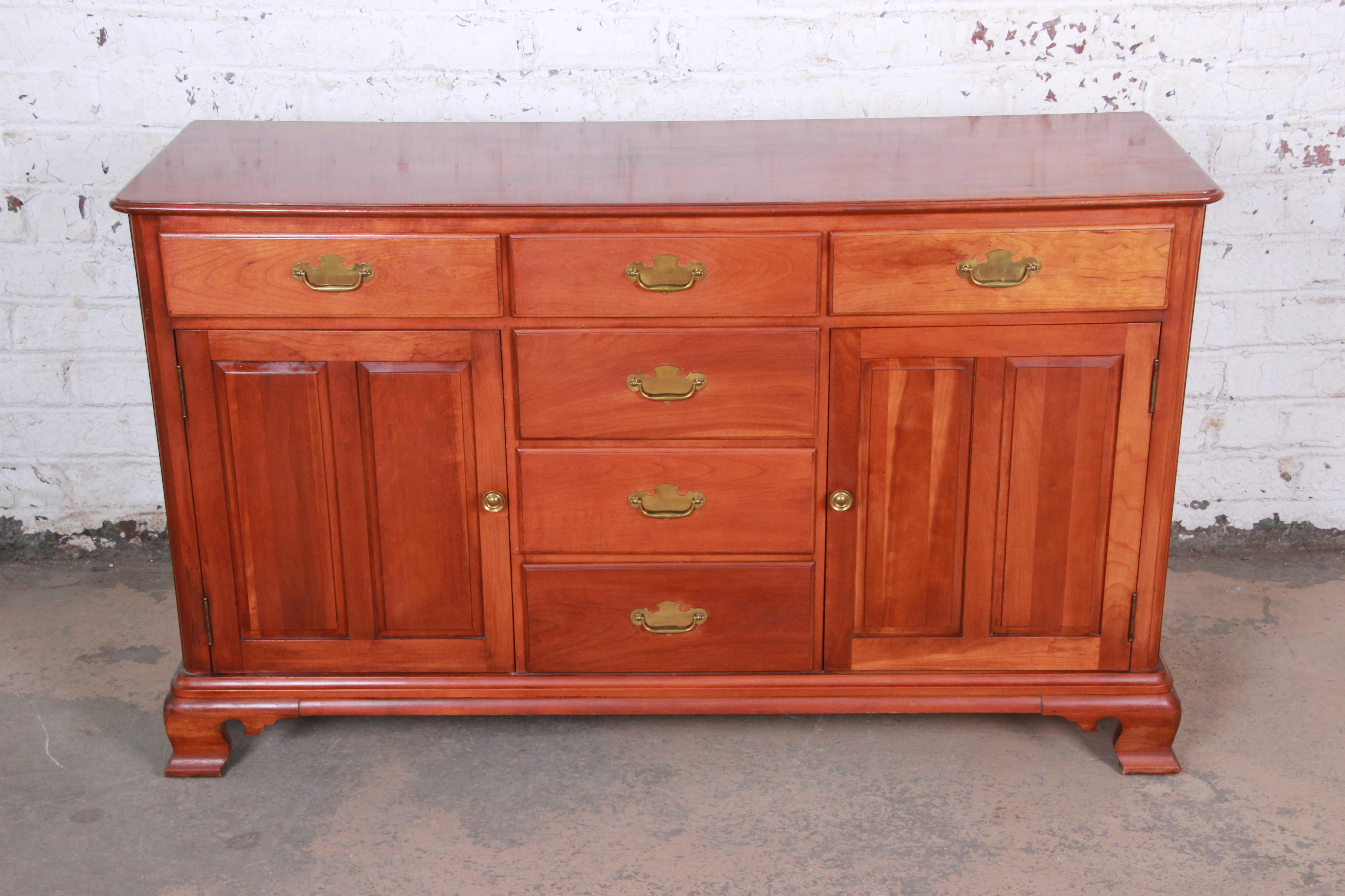 A gorgeous midcentury cherrywood sideboard credenza by Willet. The sideboard features stunning wood grain and quality American construction in solid Elswick cherry. It offers ample storage, with six dovetailed drawers and two cabinets each with a