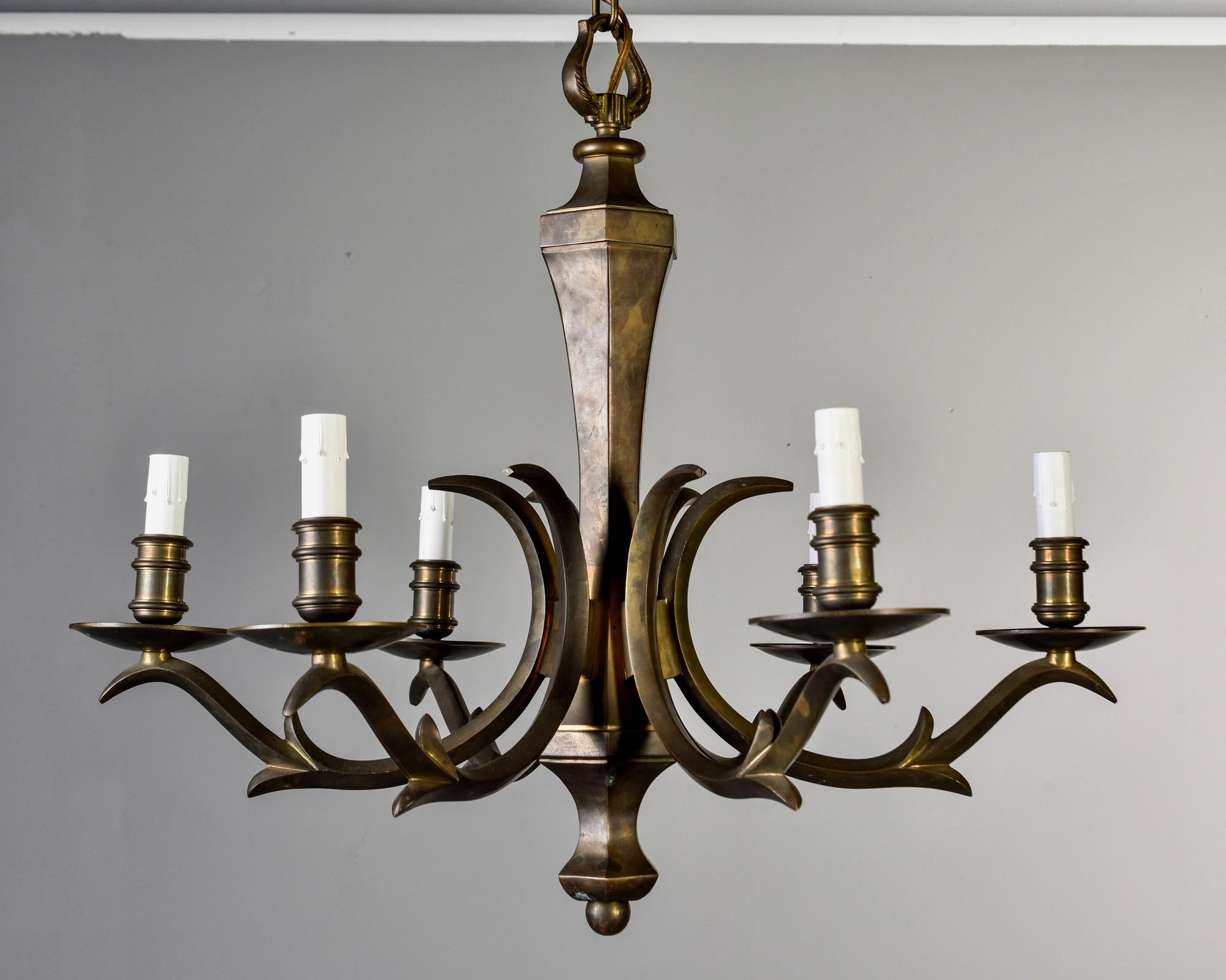 All brass six-light chandelier with candle style lights and Classic lines that work well with transitional décor, circa 1950s. New electrical wiring. Unknown maker. Very good overall vintage condition with scattered minor surface wear and dark