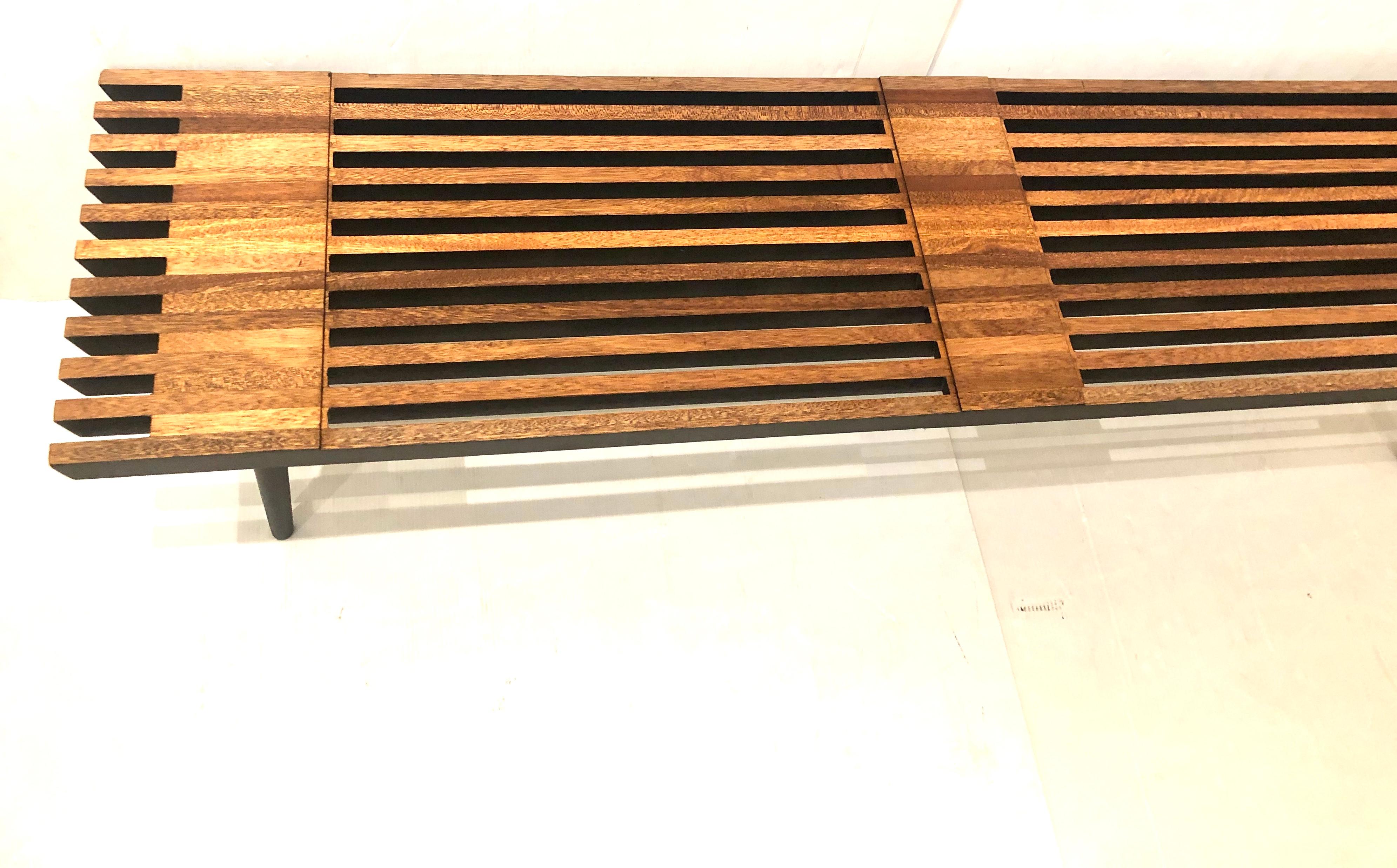 Elegant Japanese style small slat bench, circa 1950s, freshly refinished in solid mahogany with black painted finish. The piece is solid and sturdy with tapered legs that can be removed for easy storage or shipping. Nice angle edge end cut; can be