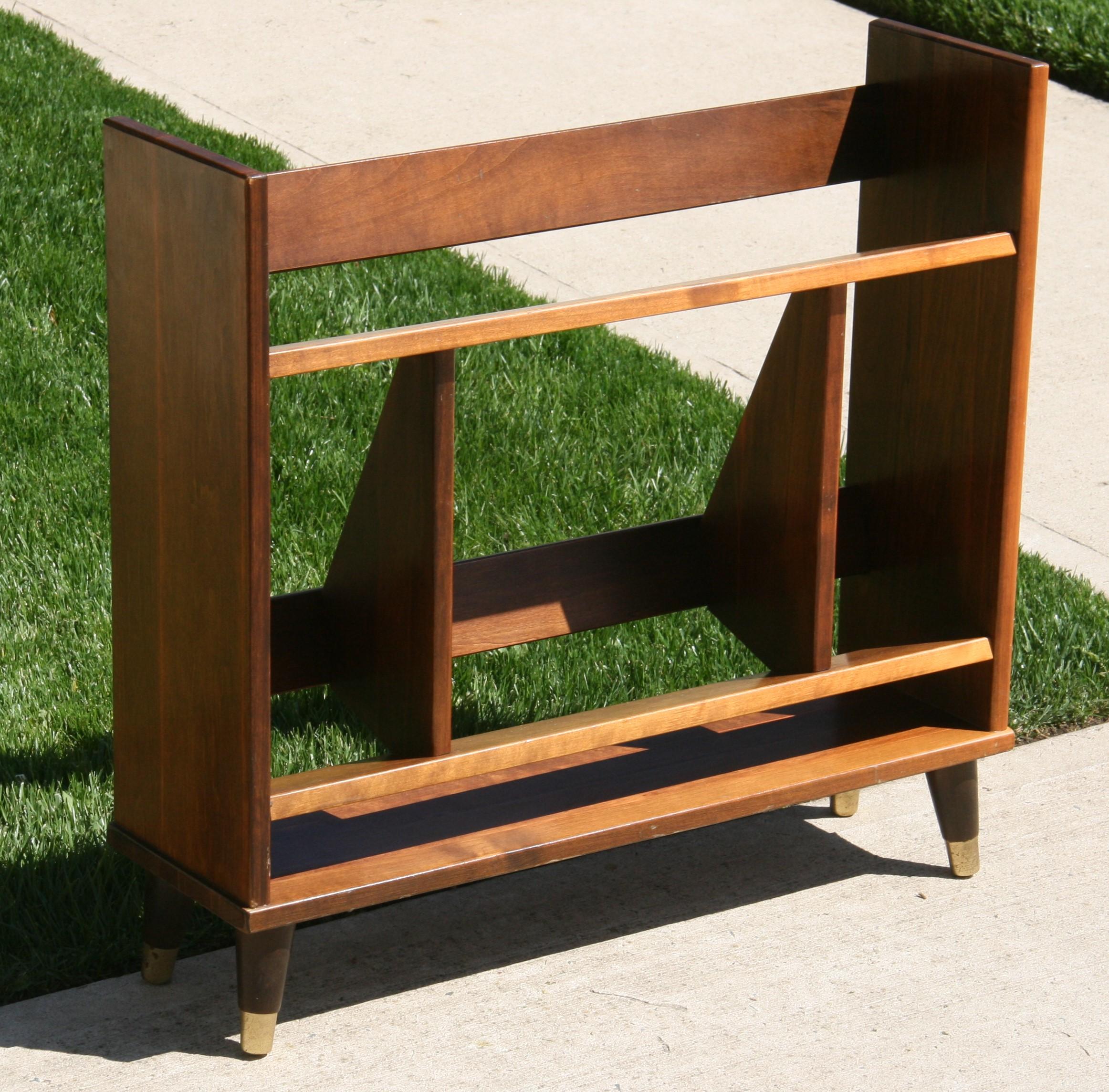 3-1099 Mid century 2 level solid maple bookcase with brass capped tapered turned legs.