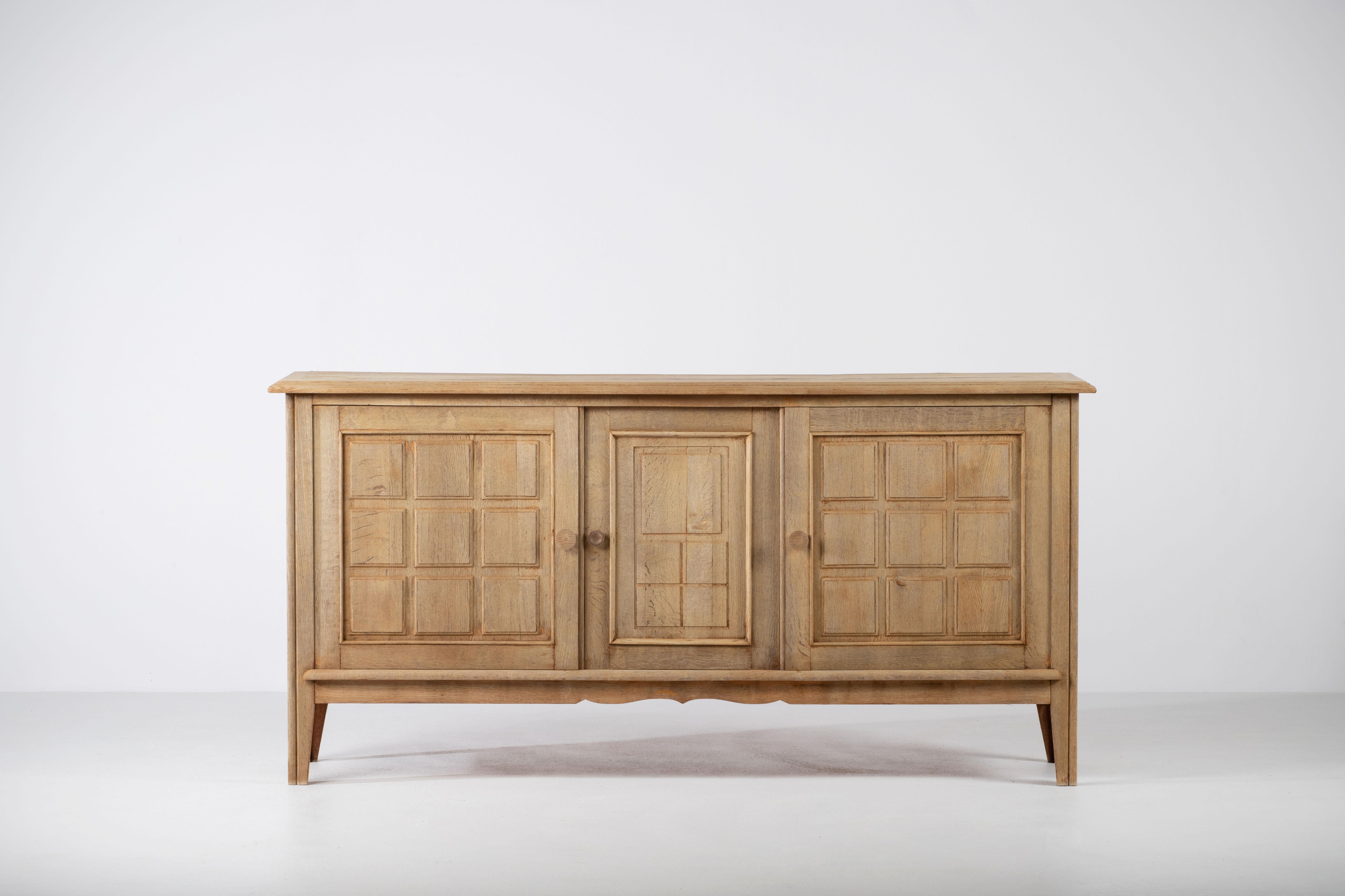 Very elegant Mid-Century credenza in solid oak, France, 1940s.
The credenza consists of three storage facilities and covered with very detailed designed doors. 
Very elegant.
 