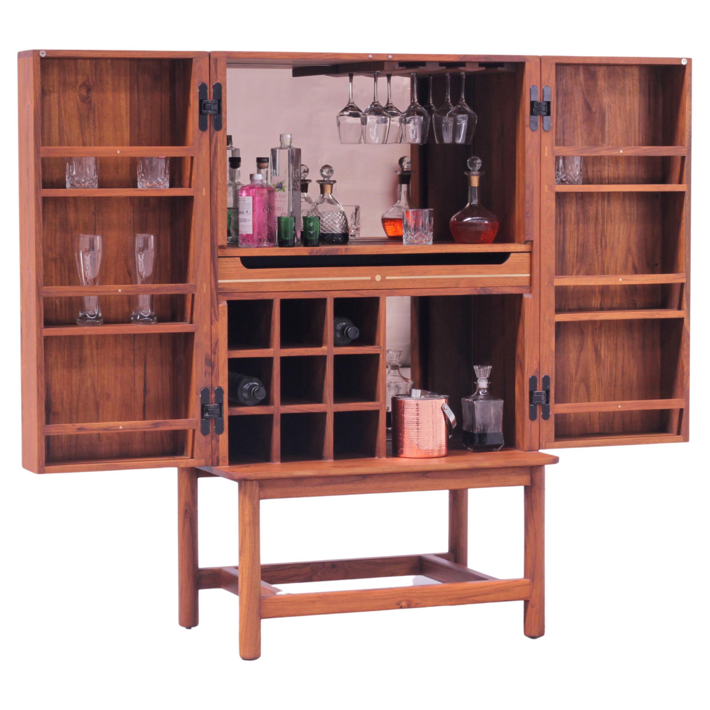 Suave is a hide-a-bar cabinet handcrafted entirely in American Oak wood with brass inlay and details. You can use it as a standalone piece of furniture for everyday living. But when it's time to celebrate, simply open the doors and unleash its