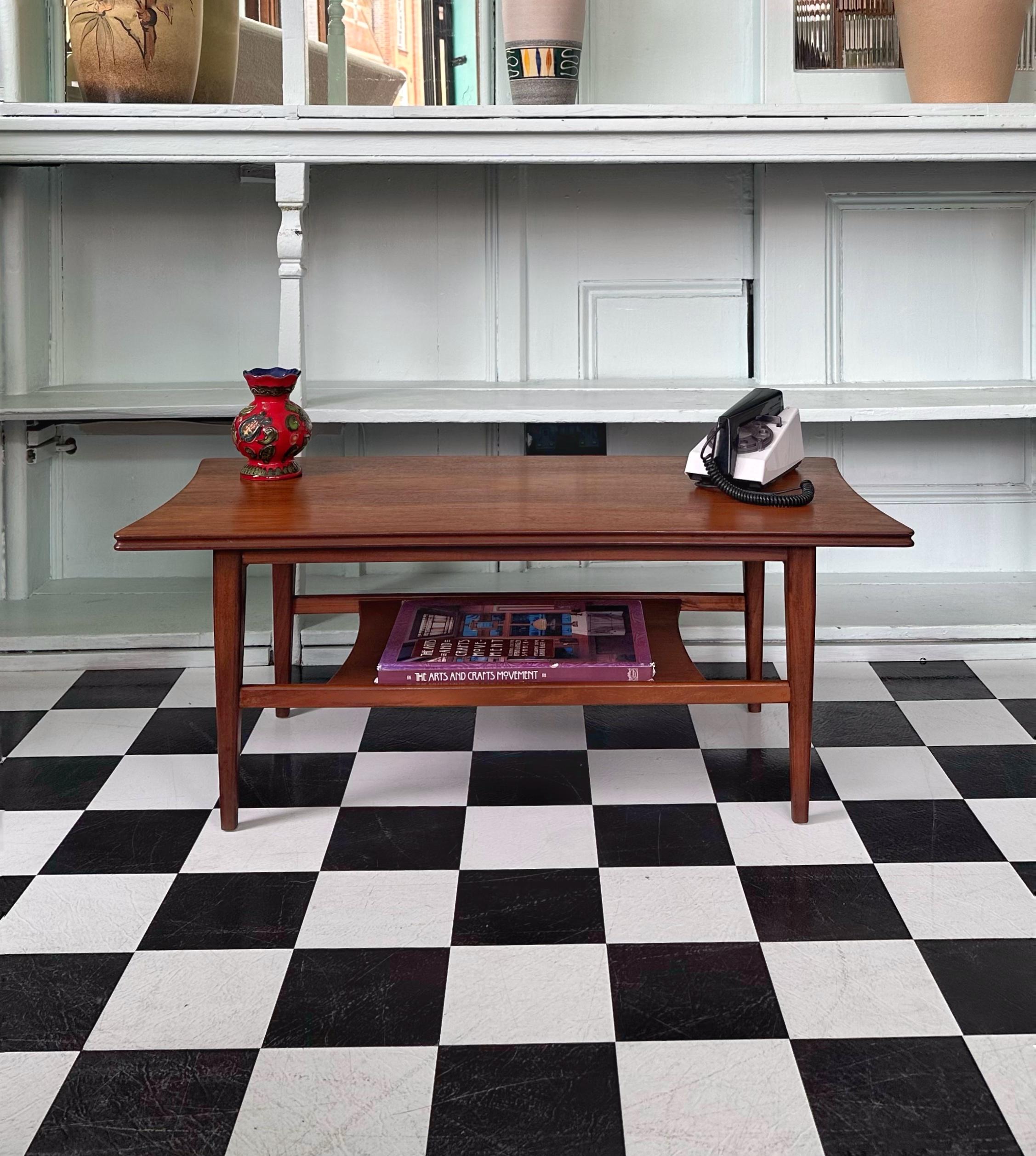 Very rare mid-century solid teak coffee table with magazine shelf by Richard Hornby for Fyne Ladye. It was designed in 1960s and retailed through Heals. An excellent example of a superb British craftsmanship throughout. Fyne Ladye Furniture of