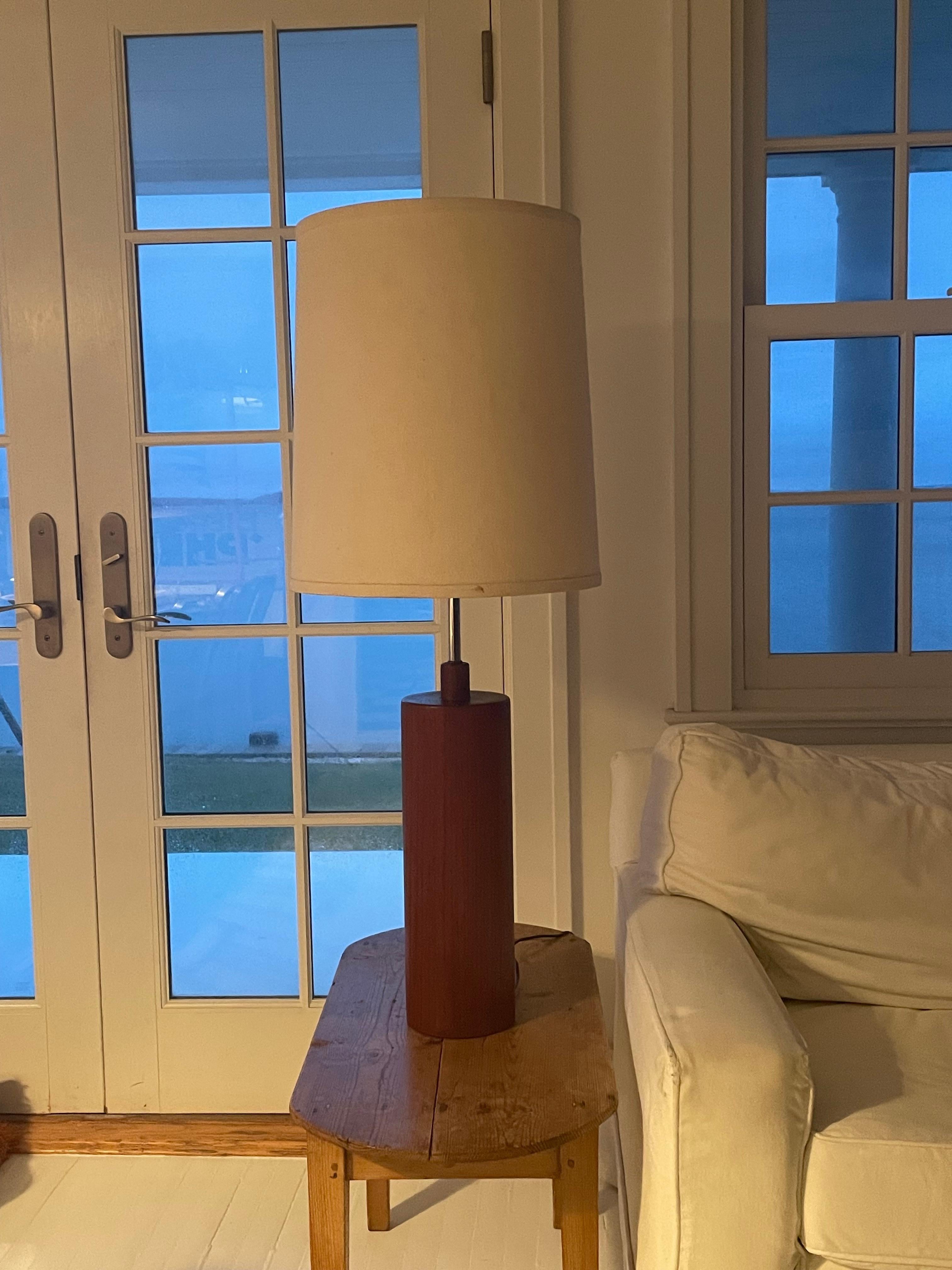Very handsome  tall, heavy and simple Danish design . The lighting element has a 3 way switch which can change the way the 5 bulbs light up for brightness. The stem from the dark teak base is chrome . 