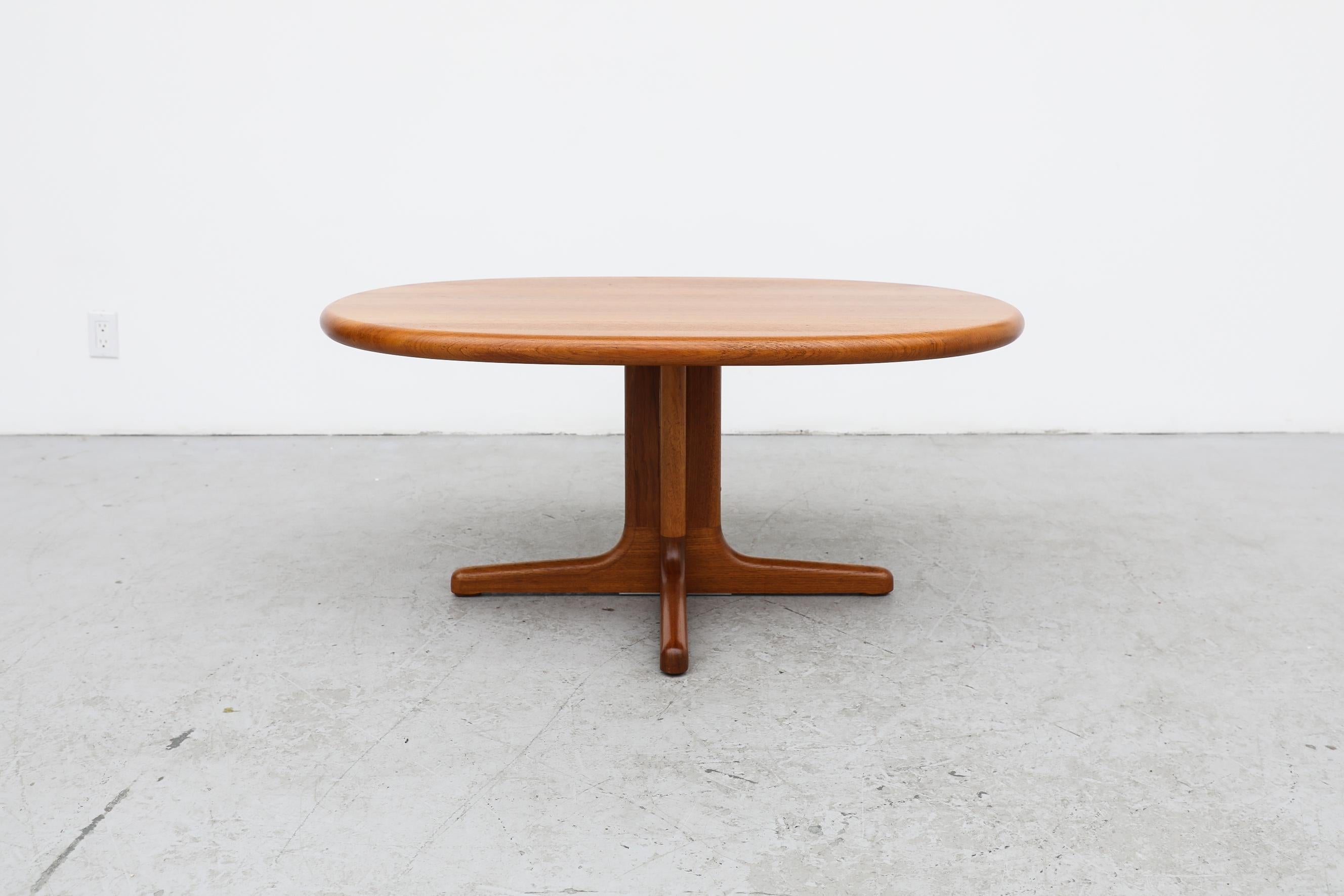 Niels Bach designed, Mid Century solid teak oval side or coffee table with pedestal base. In very good original condition with visible wear consistent with its age and use.