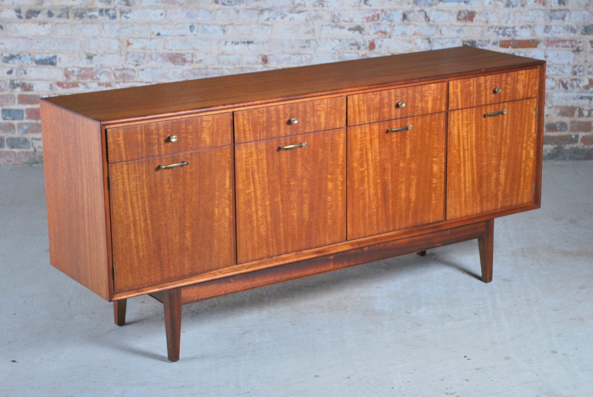 Mid century solid teak sideboard with brass handles by Greaves & Thomas, circa 1960s. 4 drawers, 2 cabinets and a drinks cabinet. Very good restored condition.

Dimension: W 220cm x H 76cm x D 45cm.