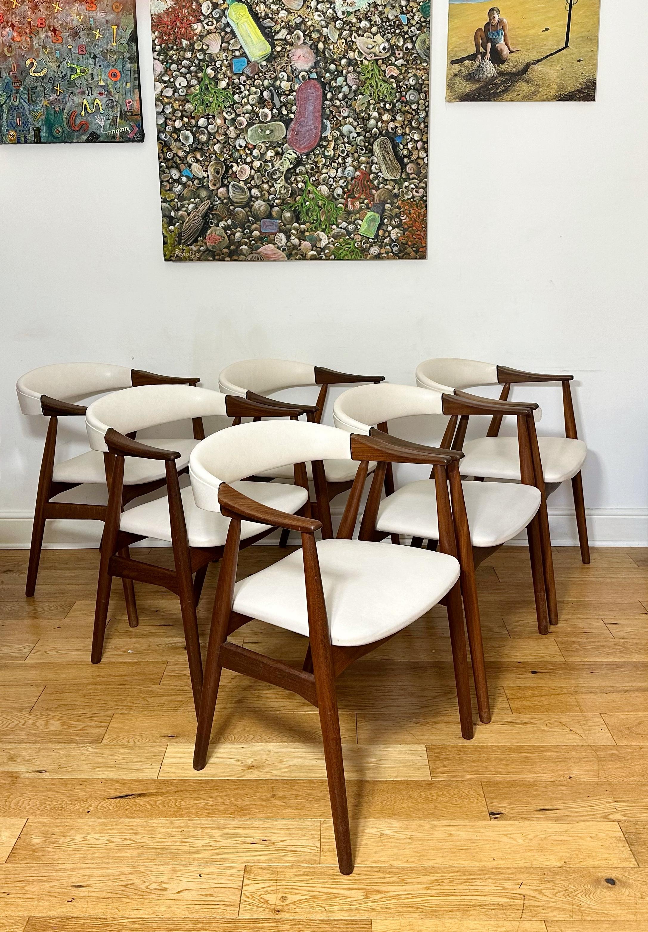 Stunning set of six Mid-Century Danish teak armchairs / dining chairs by Th. Harlev for Farstrup Møbler, Model 213. Beautifully designed with solid teak frames, curved backrest and angled frame. Upholstered in original cream vinyl which is still in