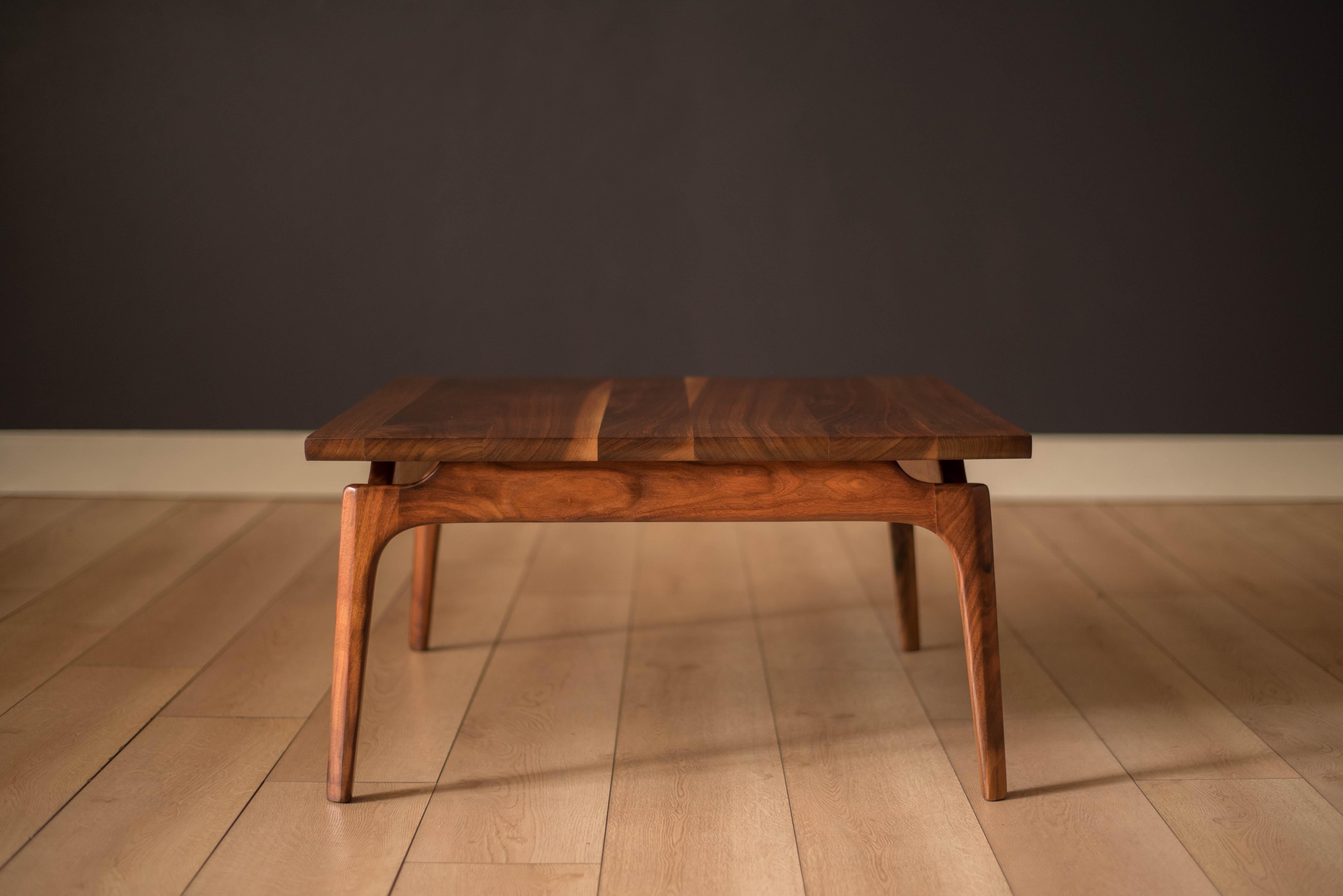 Vintage coffee or occasional table in solid planked walnut, circa 1960s. Features a floating tabletop design supported by contoured sculpted legs.





Offered by Mid Century Maddist