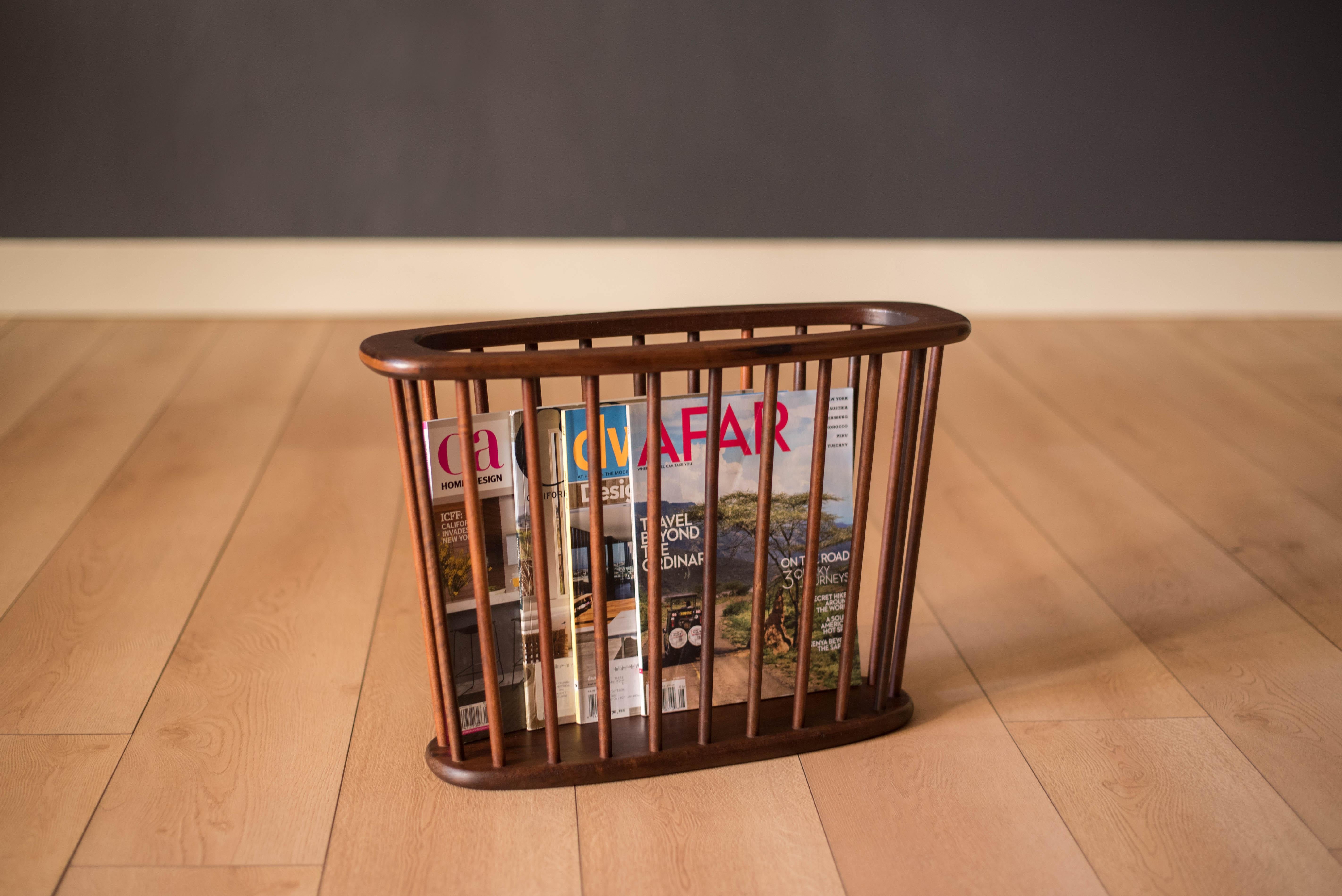 Vintage magazine holder designed by Arthur Umanoff for Washington Woodcraft, circa 1960s. This organizing rack is constructed of solid walnut and is perfect for displaying light reading material.