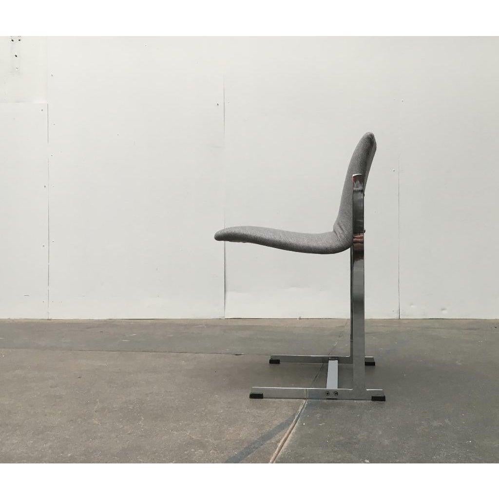 Minimalist chair with a distinctive cantilever by Merrow Associates based on a design by Richard Young from the 1960s.

The projection of the seat shell is particularly eye-catching. The frame catches these easily. The frame is particularly narrow