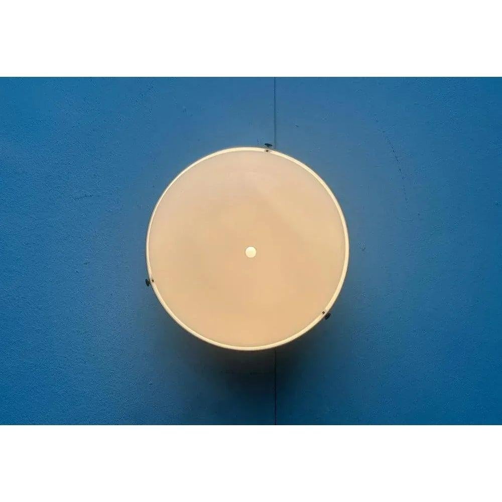 Very rare ceiling or wall lights from the cartel according to a design by Gianemilio, Pietro and Anna Monti from the late 1950s.

A functional design. The luminaire body is made of metal and is painted white. An all -round perforation in the base
