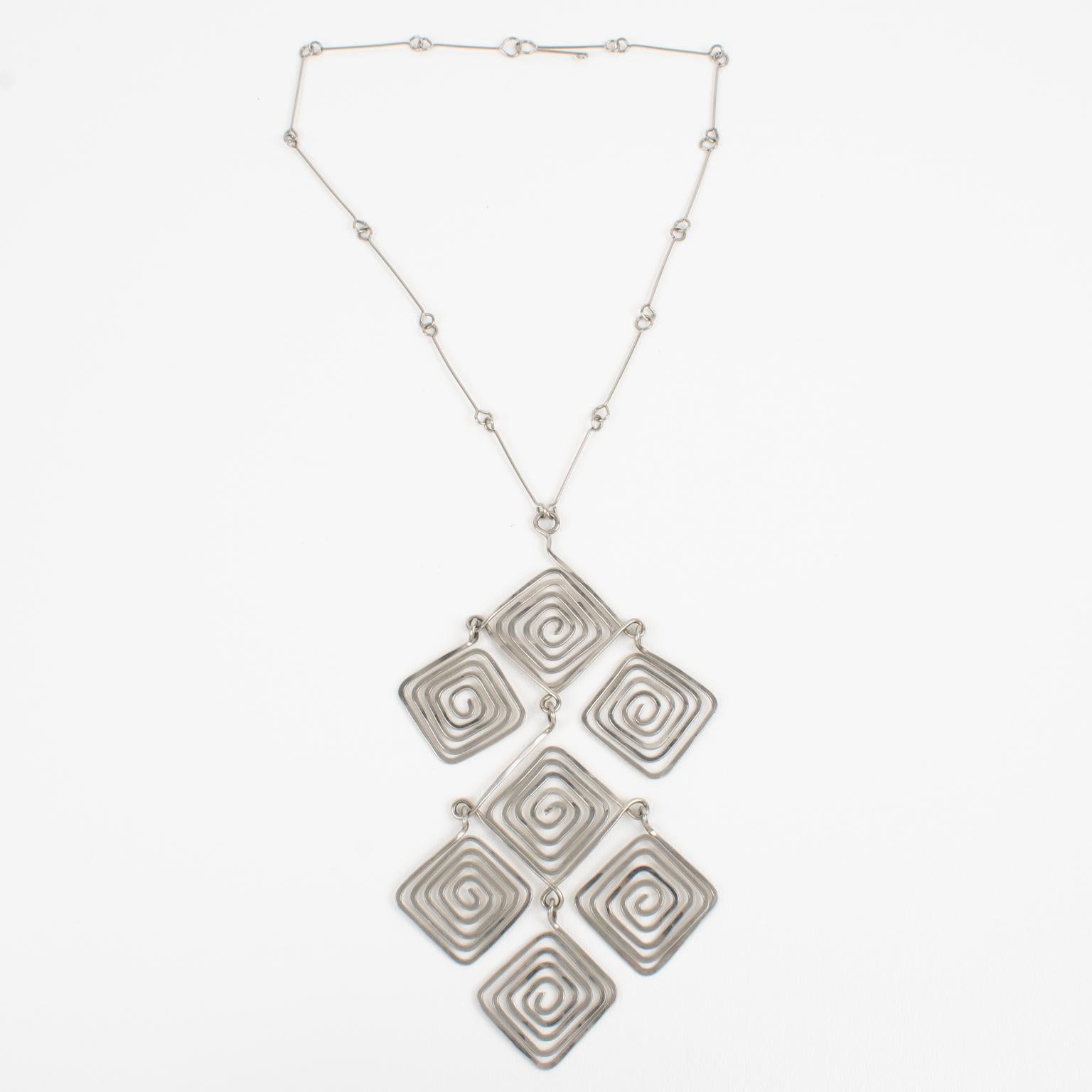 This elegant Mid-Century Modern Space Age long metal necklace with a geometric pendant was handmade in the 1960s in France. The piece features a chromed metal articulated wired chain and is ornate with an impressive geometric dangling pendant. The