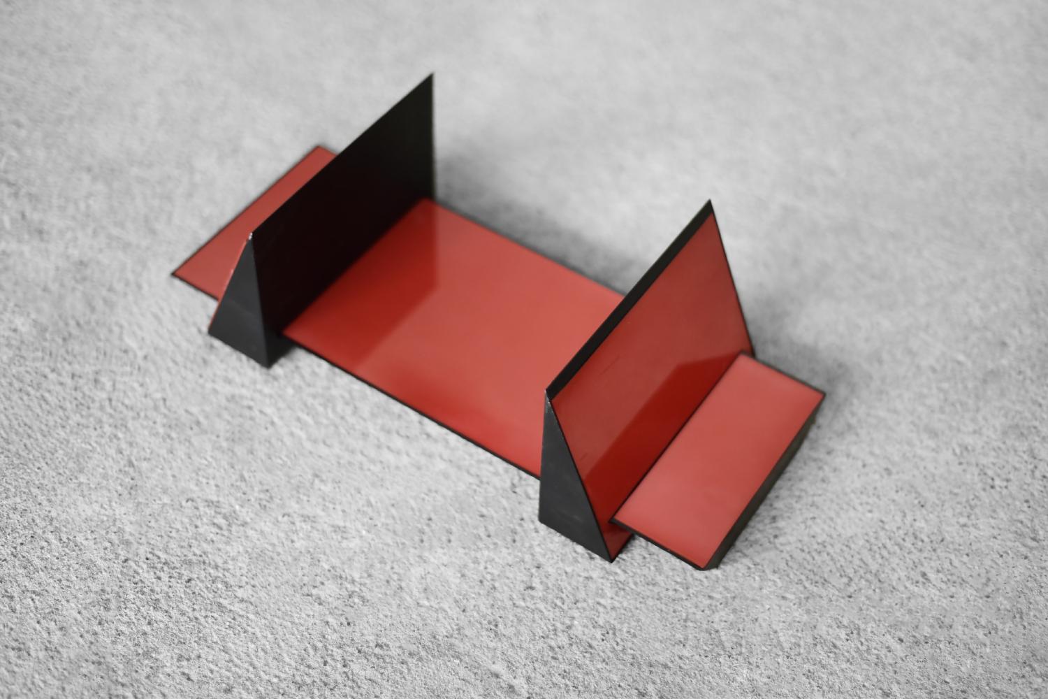 This rare book or CD stand was designed by Corus Associati Ancona and produced by the Italian manufacturer MGL Plast Fabriano during the 1980s. The original paper box with graphics characteristic of the era has also been preserved (particularly
