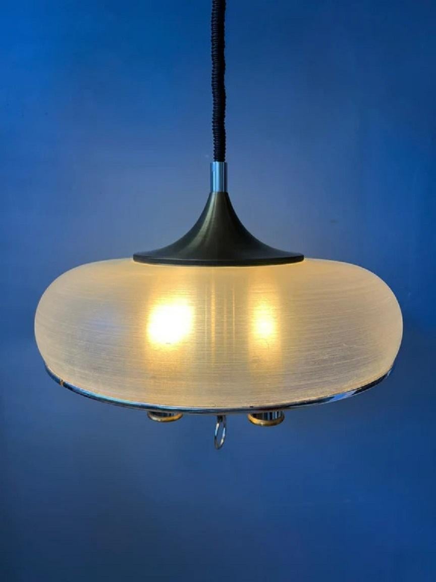 Rare space age pendant lamp with acrylic glass outer shade and inner chrome 4-bulb 'chandelier'. The height of the lamp can be easily adjusted with the rise-and-fall mechanism. The lamp requires 4 E26/27 lightbulbs.

Dimensions:
ø: 47 cm
Height